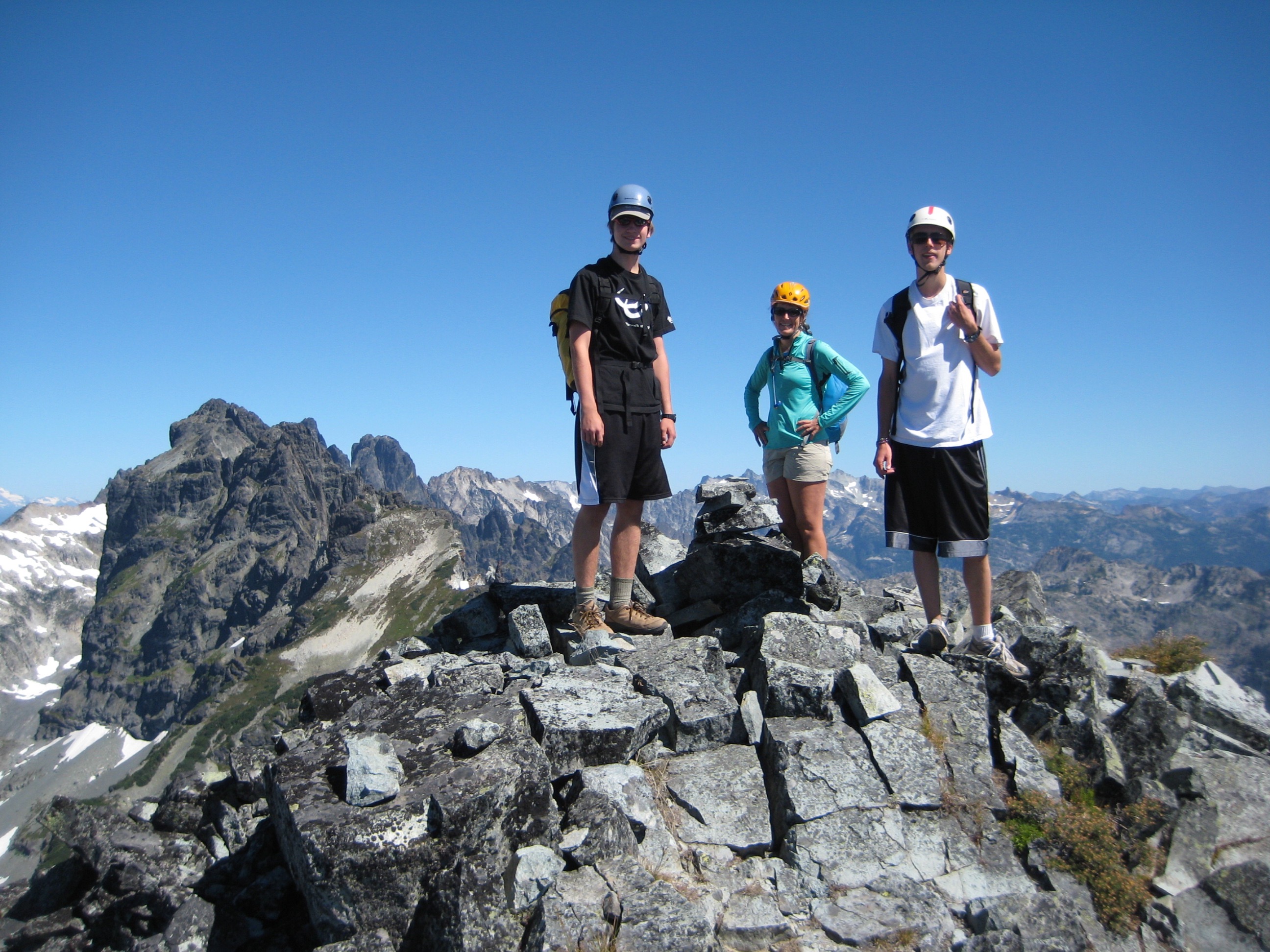 climbers on the rocky summit of Chikamin Peak in the Snoqualmie Mountains