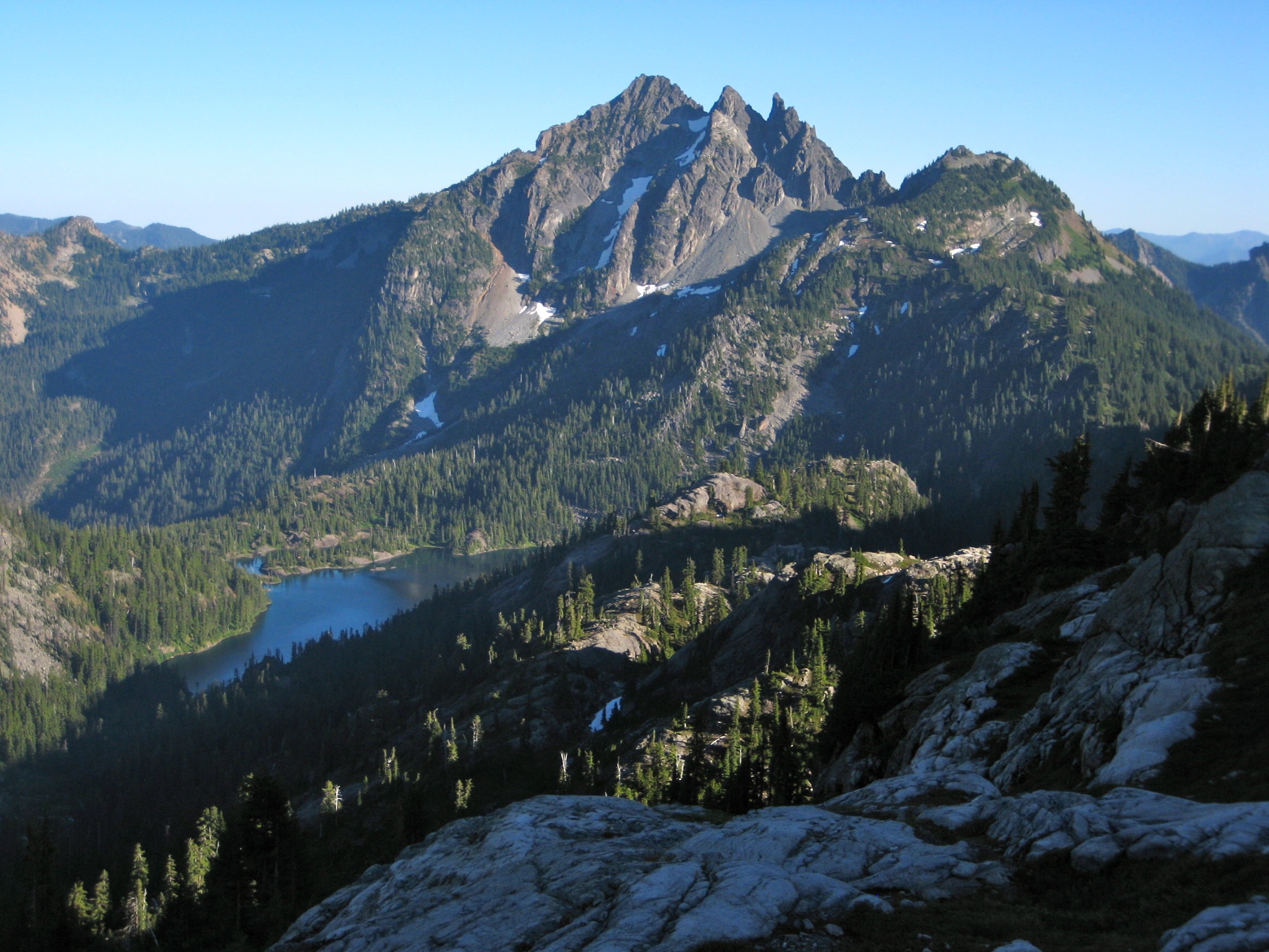 Three Queens Mountain high above Spectacle Lake surrounded by evergreen trees