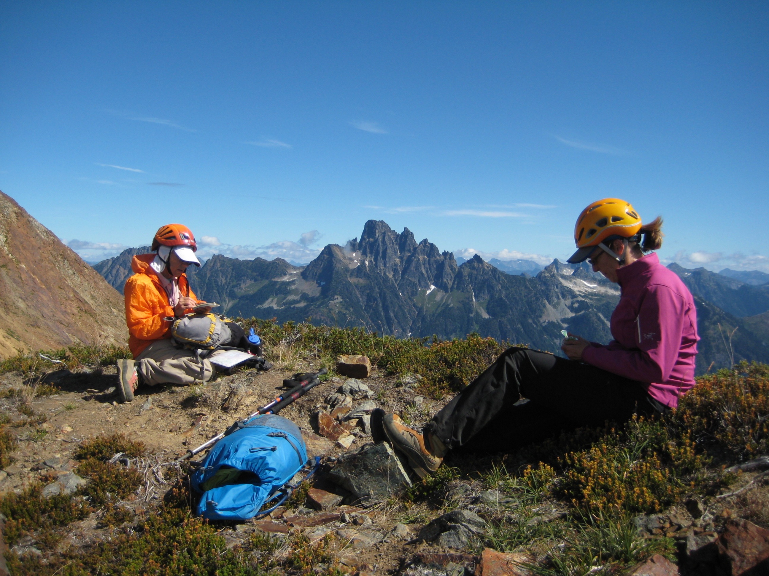 mountain climbers taking a break on the south American Border Peak saddle with mountains in the background
