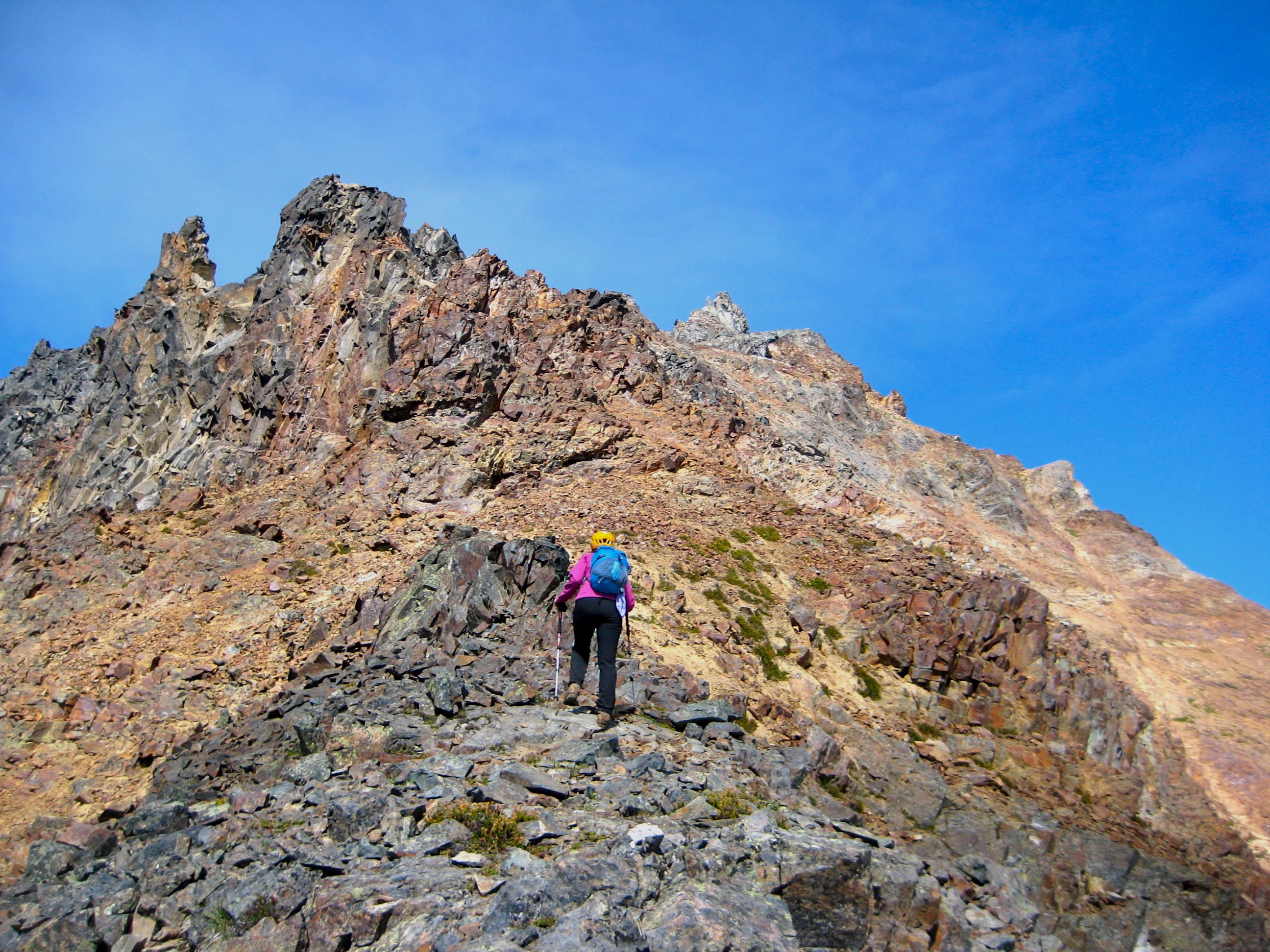 mountain climber hikinh up the south ridge of American Border Peak in the Mt Baker WIlderness 