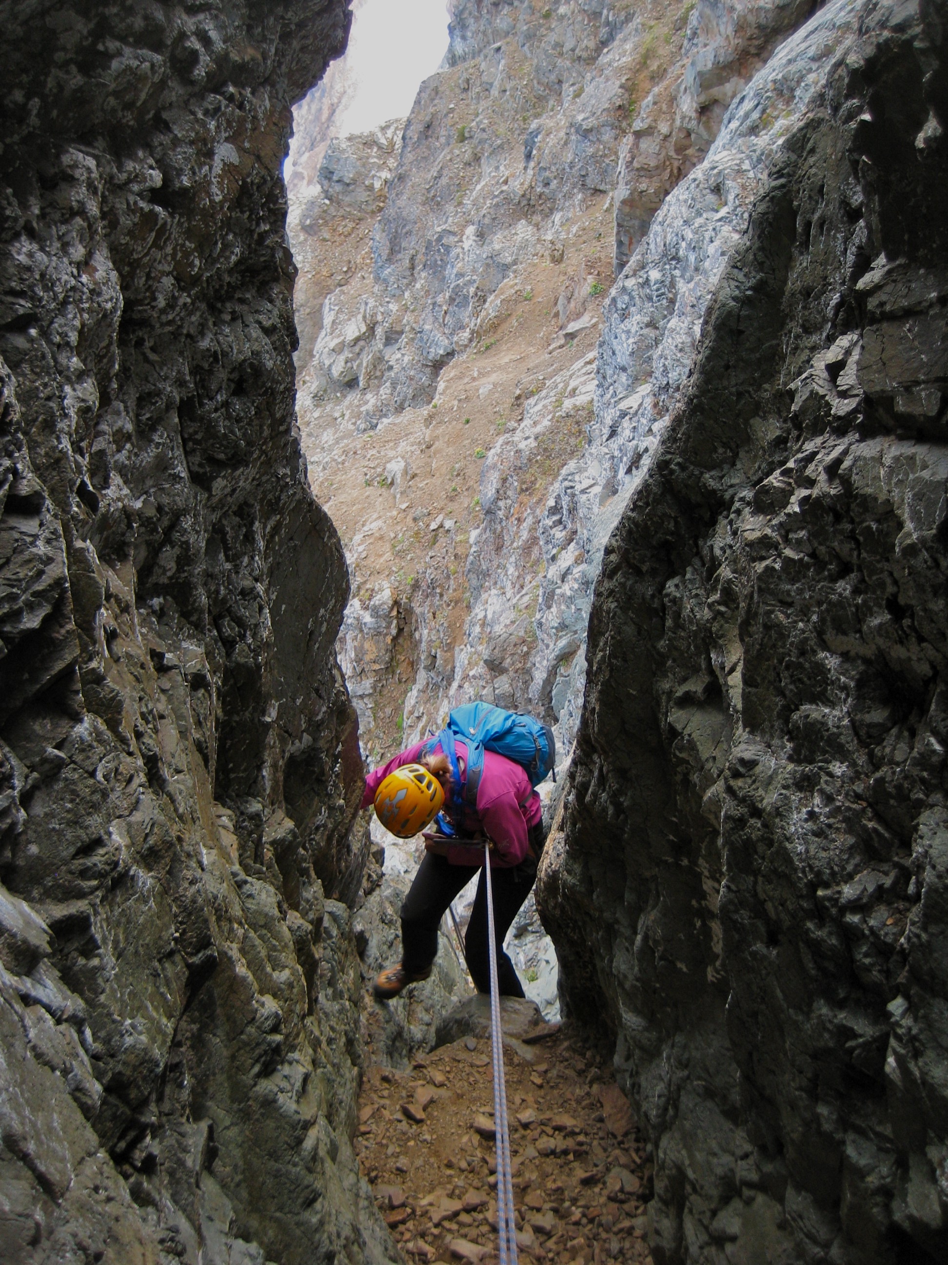 mountain climber rappelling rocky chimney on American Border Peak in the Mt Baker Wilderness