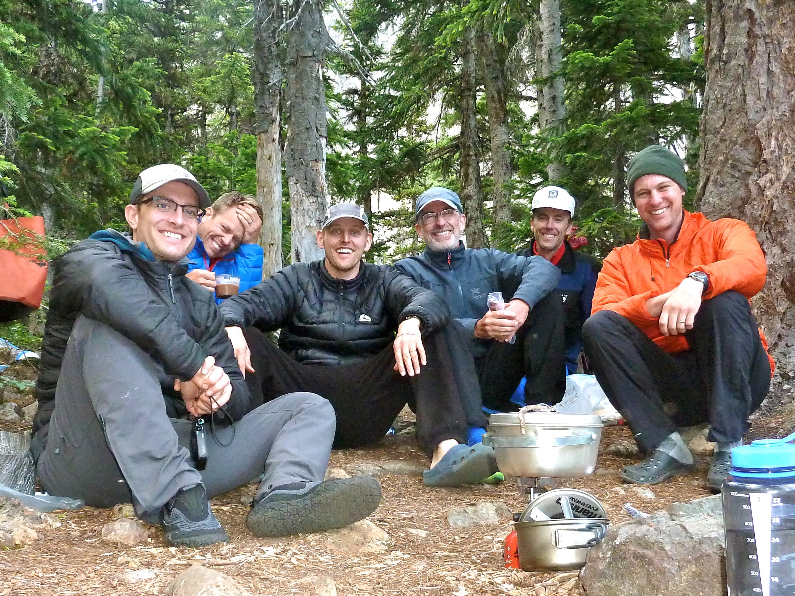 group of mountain climbers in forest camp having dinner in the Olympic National Park