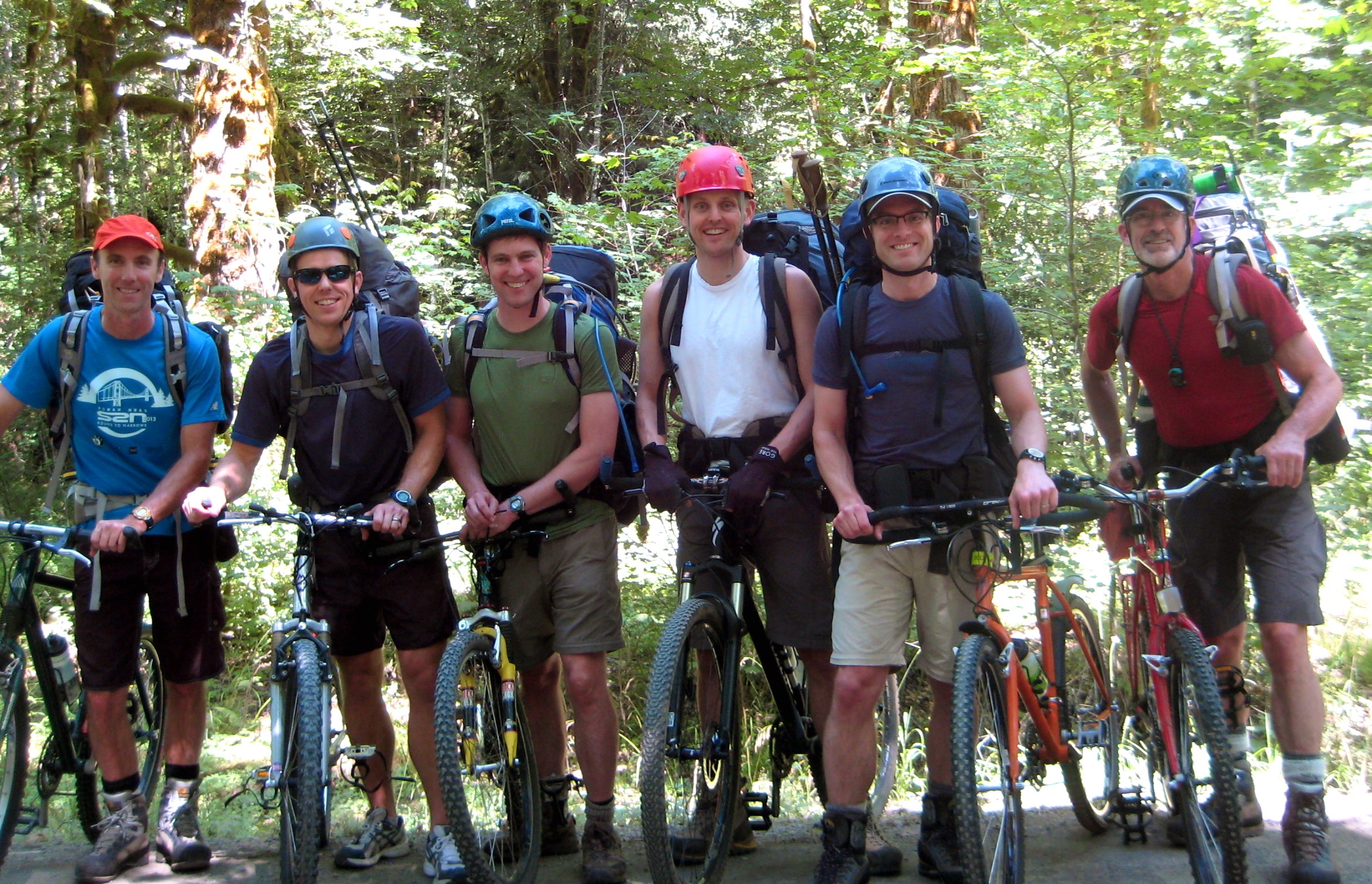 mountain climbers with mountain bikes ready to bike up dirt road to Mt Constance in the Olympic Mountains