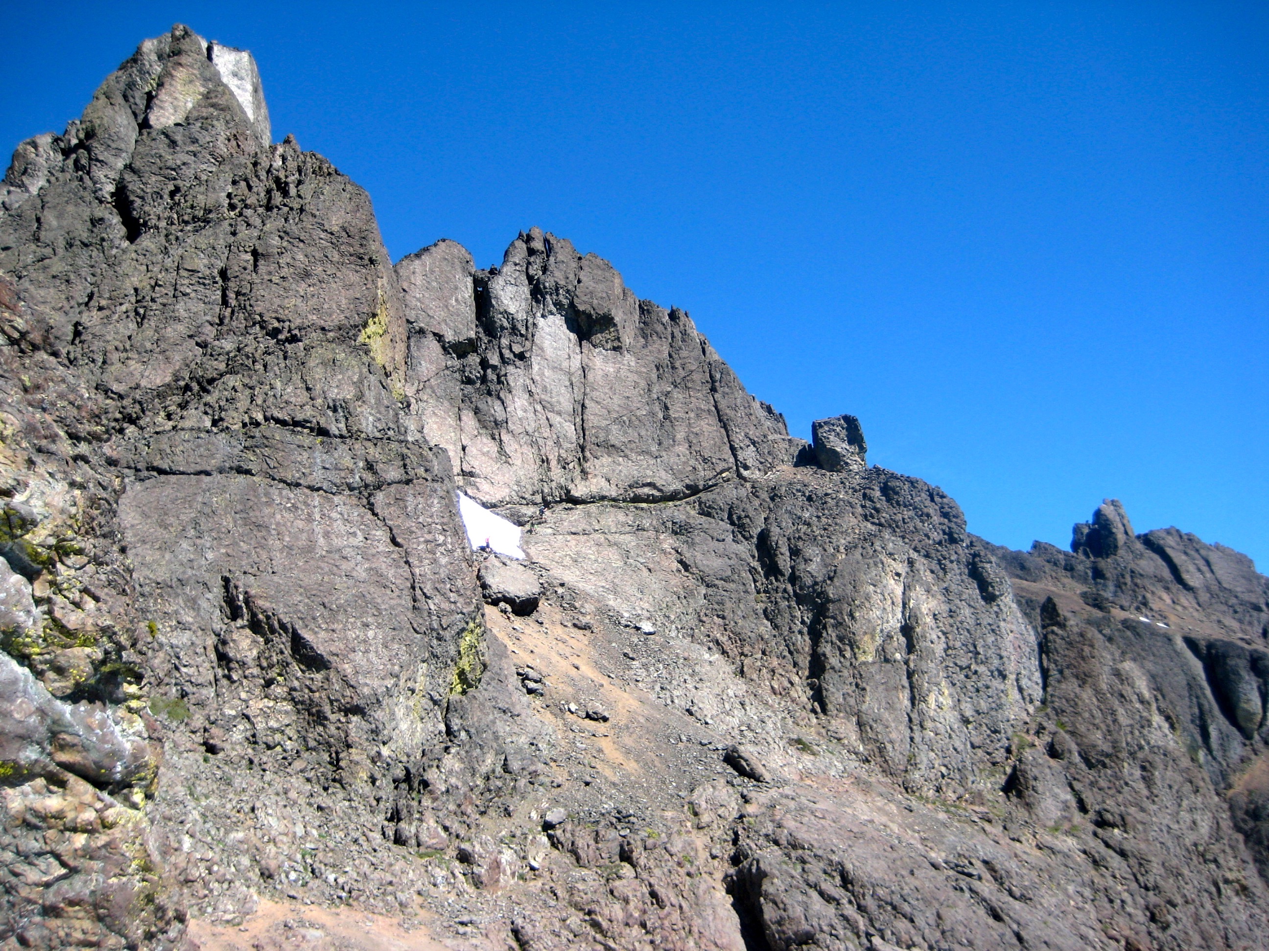 traverse route across rock ledge towards Cubic Boulder on the ridge line on Mt Constance in the Olympic Mountains