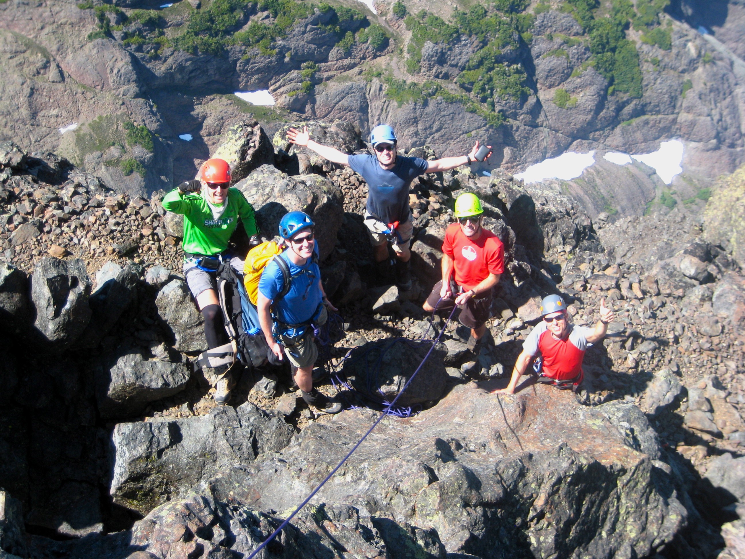 group of mountain climbers below the summit of Outer Constance Peak waiting to rope up and climb the summit rock
