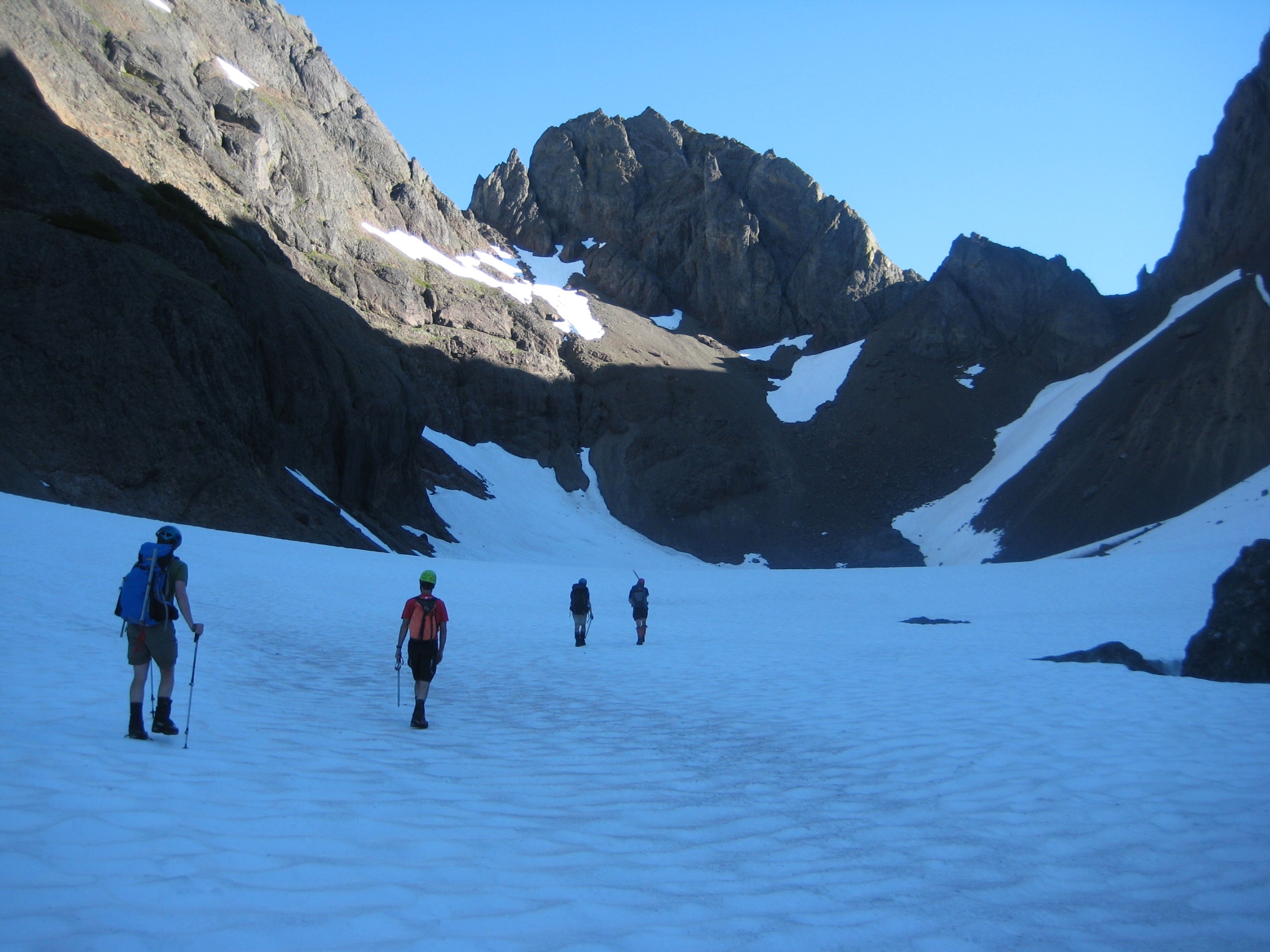 mountain climbers booting up snow field of Avalanche Canyon heading to Mt Constance Peak in the Olympic Mountains