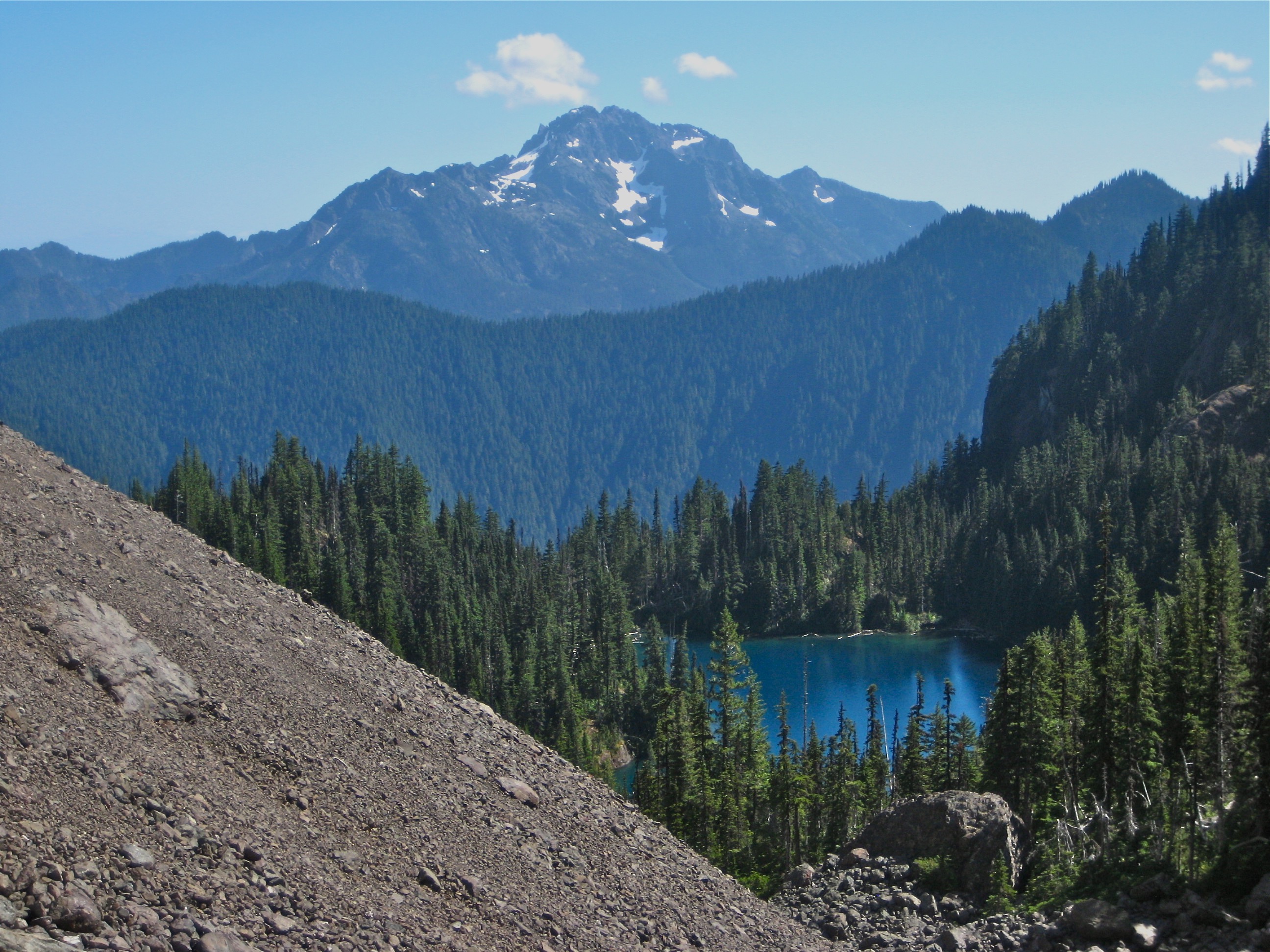 The Brothers and Lake Constance with a sloping scree field and evergreen trees in the Olympic Mountains