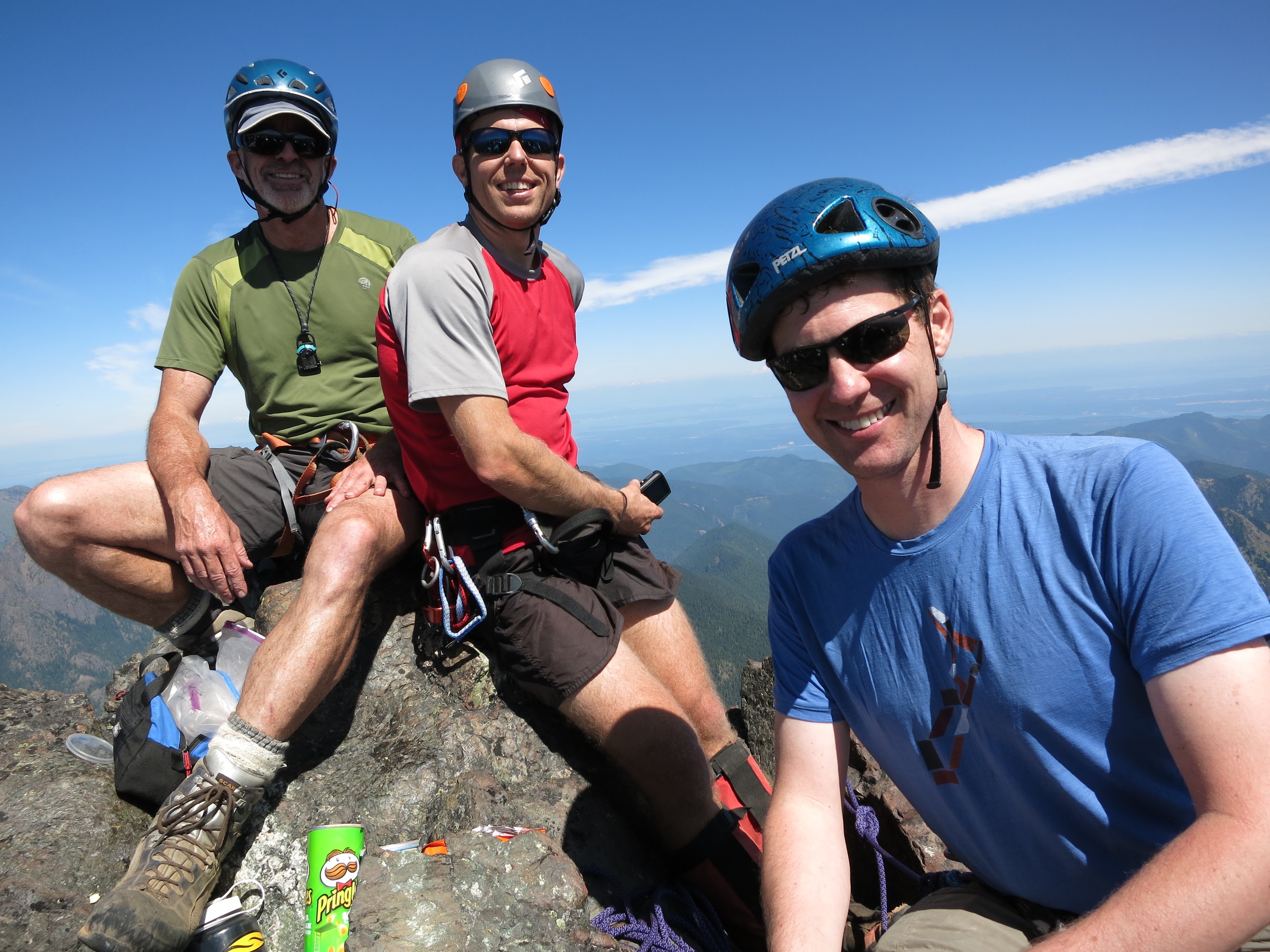 mountain climbers on the summit horn of Mt Constance Outer Peak in the Olympic Mountains