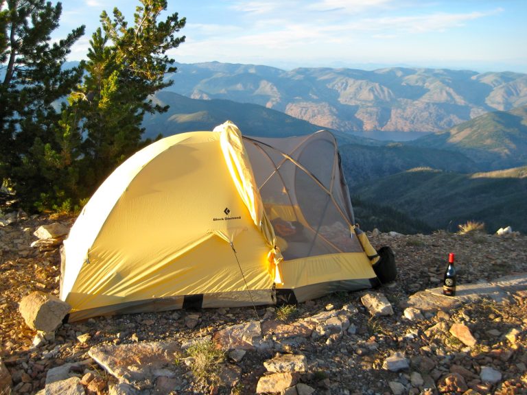 A yellow tent sits on summit of Stormy Mountain overlooking Lake Chelan