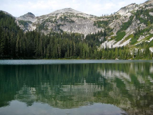 Rainbow Lake with rocky Rainbow Ridge in the background in the Stehekin Mountains