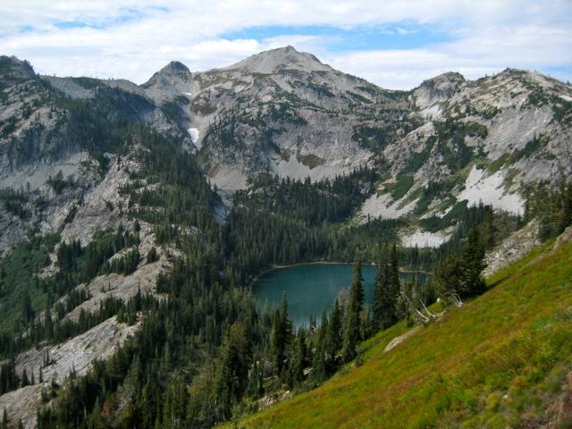Looking down on Rainbow Lake in the basin of rocky hills in the Stehekin Mountains