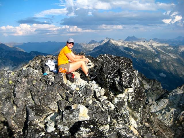 mountain climber taking a break on the rocky summit of Bowan Mountain in the Stehekin Mountains