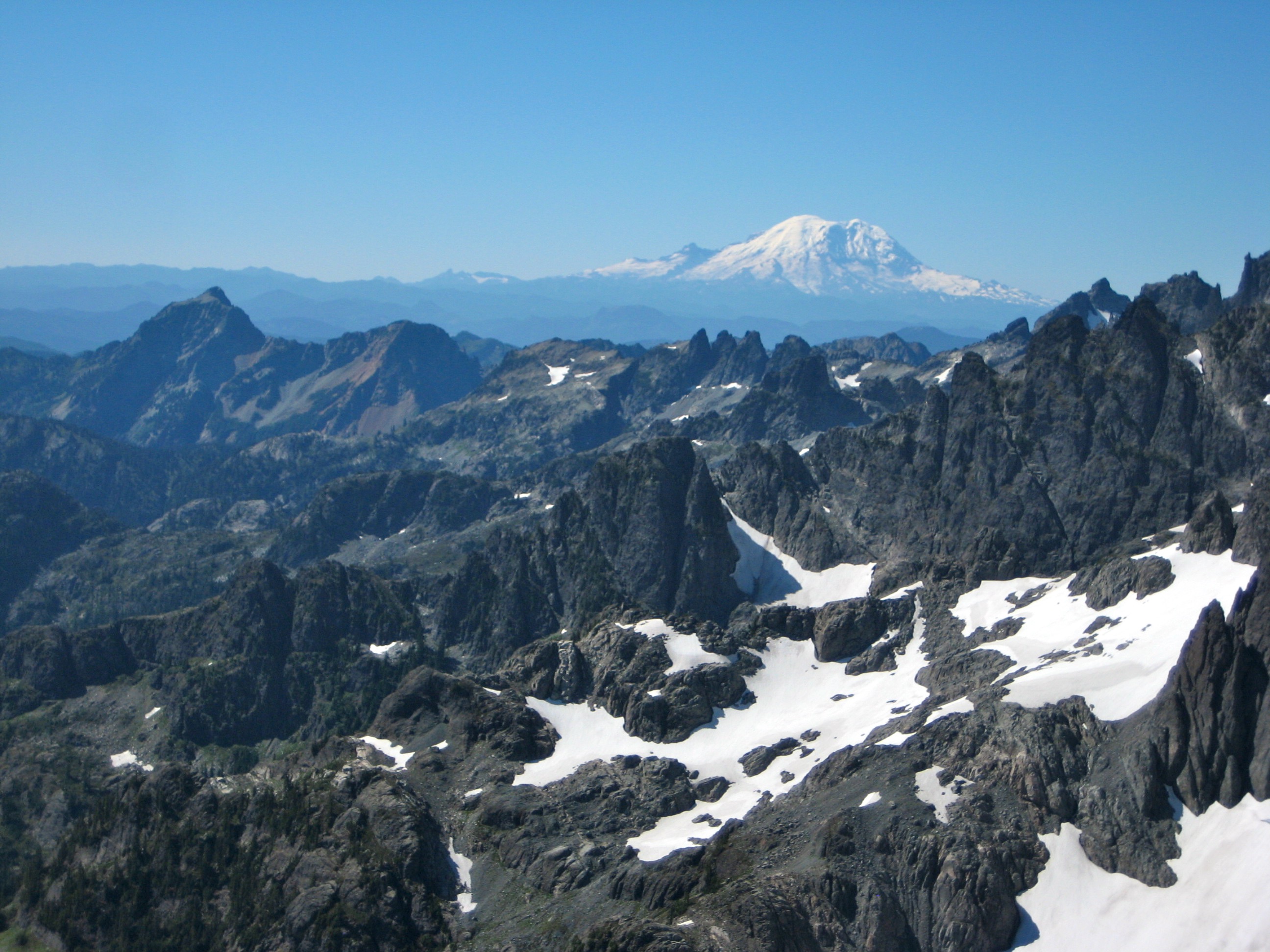 Hibox Peak, Four Brothers Peaks, and Chikamin Peak in the Snoqualmie Mountains with Mt Rainier as seen from the summit of Summit Chief Mountain