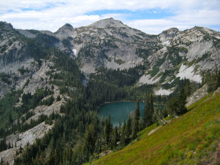 Looking down on Rainbow Lake in a rocky bowl as seen from Bowan Pass in the Stehekin Mountains on the Rainbow Ridge Loop