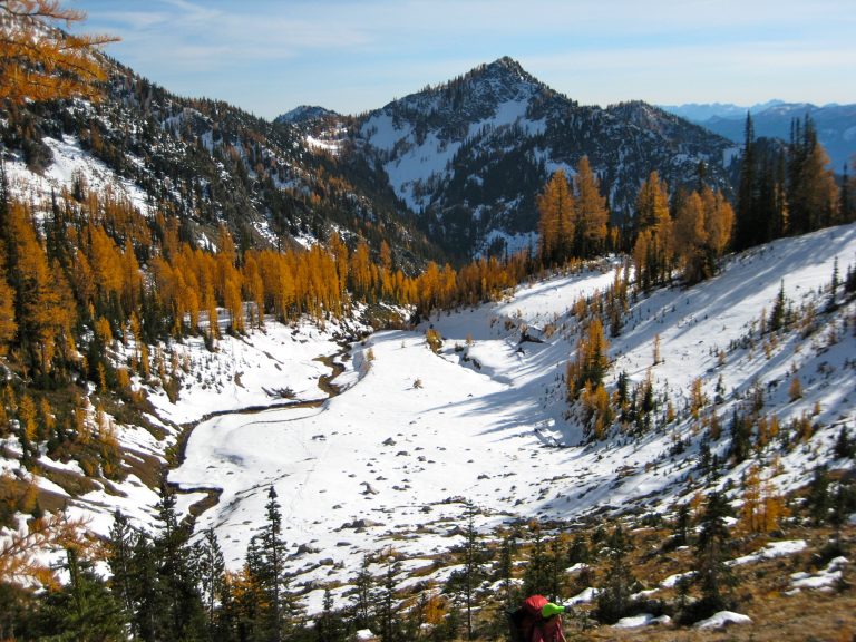 Looking down at a snowy basin along the Carne--Leroy Loop in the Entiat Mountains with Carne Mountain in the background