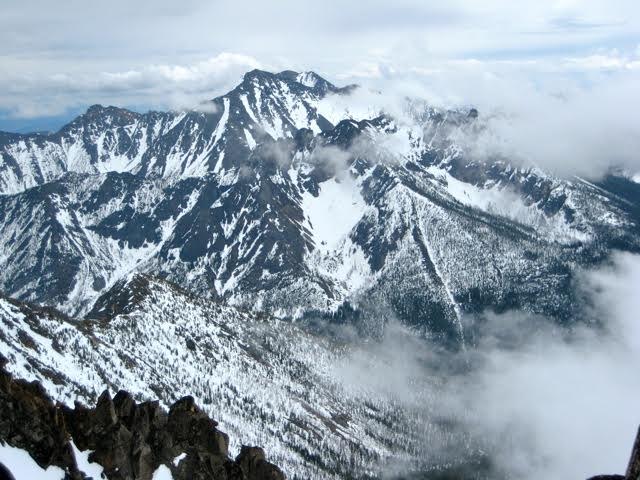 snowy North Gardner Mountain in the North Cascades with drifting clouds as seen from the summit of Silver Star Mountain in the Mazama Mountains 