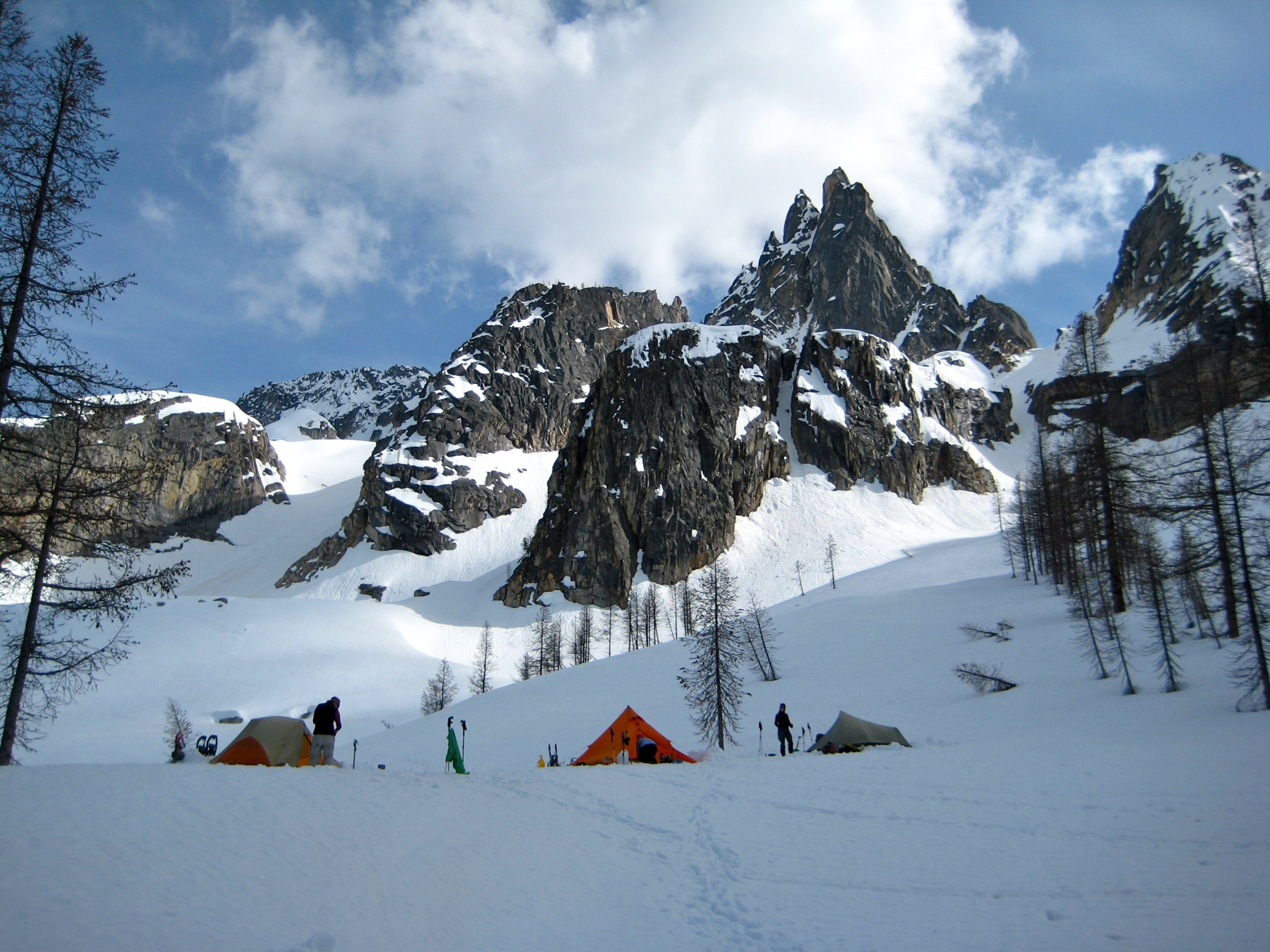 evening light on the Wine Spires of Silver Star Mountain in the Mazama Mountains with mountain climber's camp in the snow filled basin below
