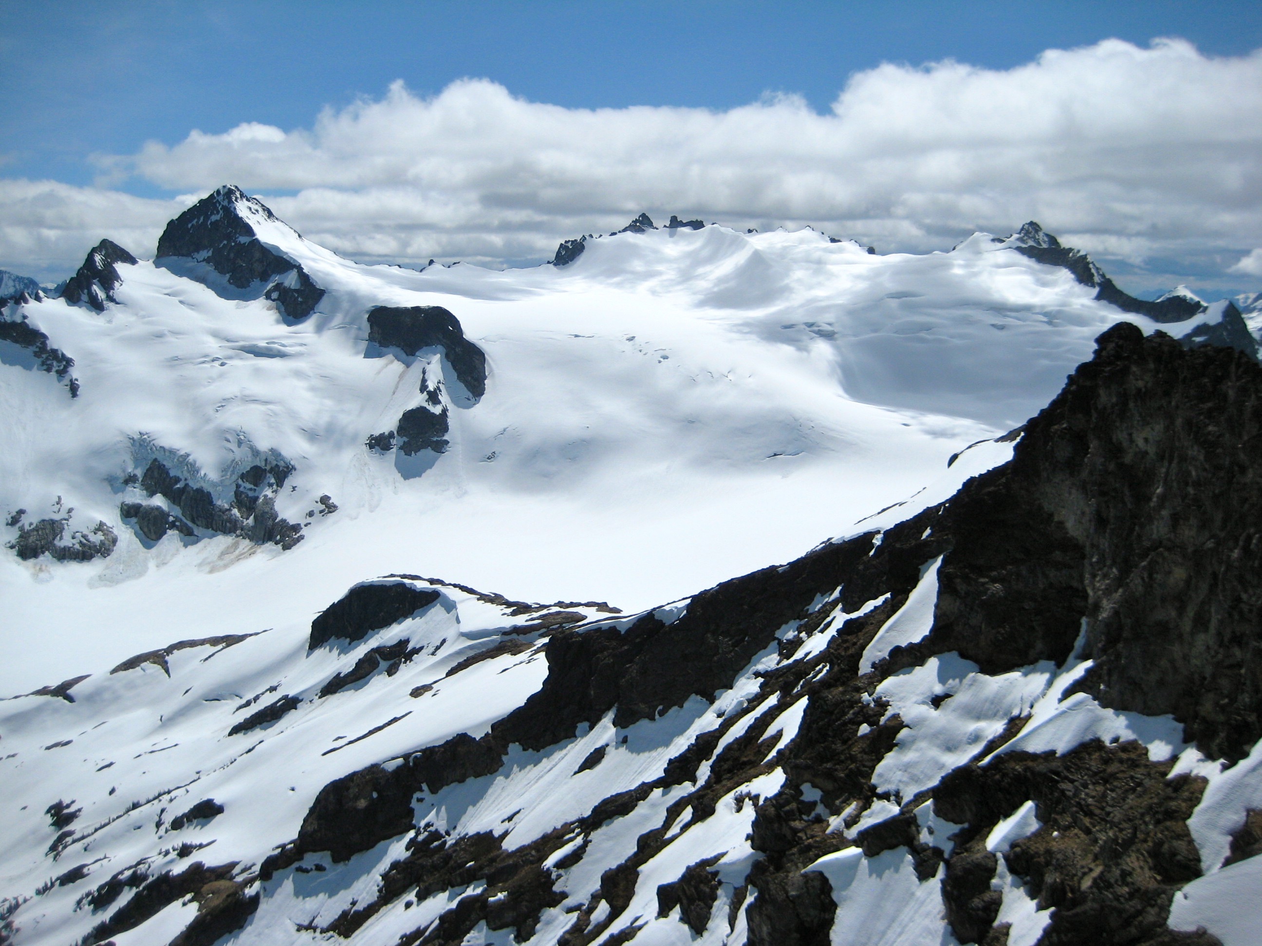 Snowfield Peak in the McAllister Mountains and snow filled Neve Glacier as seen from Colonial Peak in North Cascades National Park