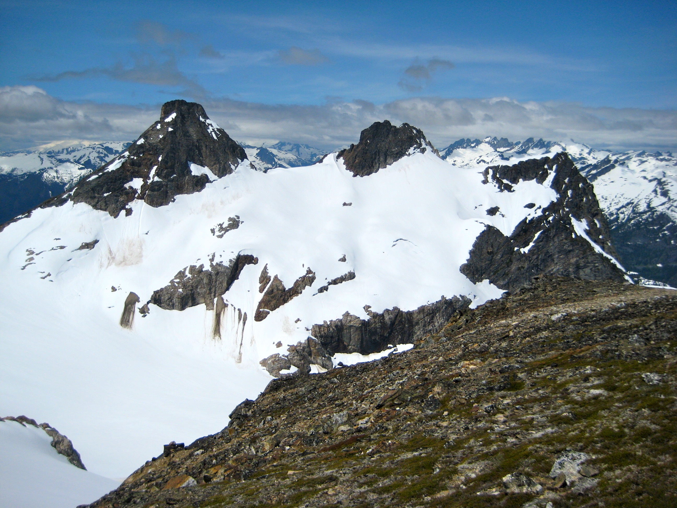 Paul Bunyan's Stump, Pinnacle Peak, and Pyramid Peak in the McAllister Mountains in the background with the shoulder of Colonial Peak in North Cascades National Park in the foreground