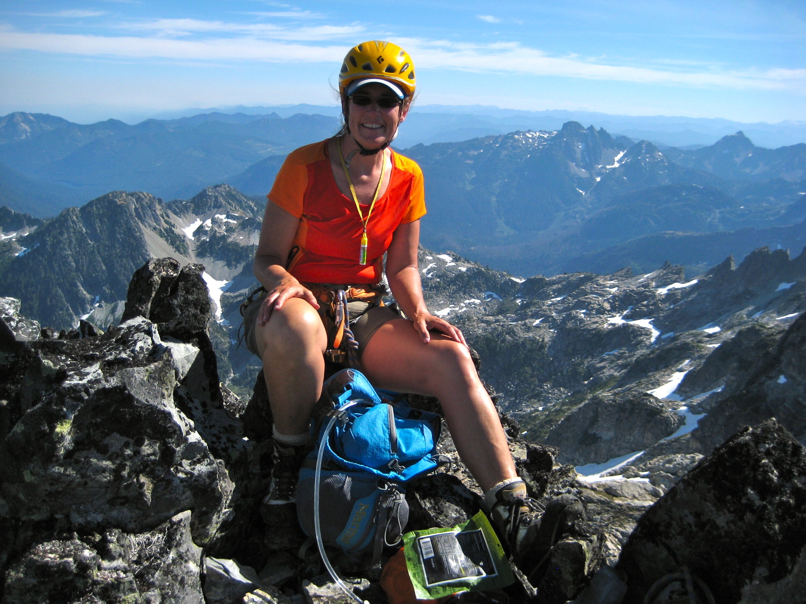 mountain climber on the rocky summit of Little Big Chief Peak in the Snoqualmie Mountains