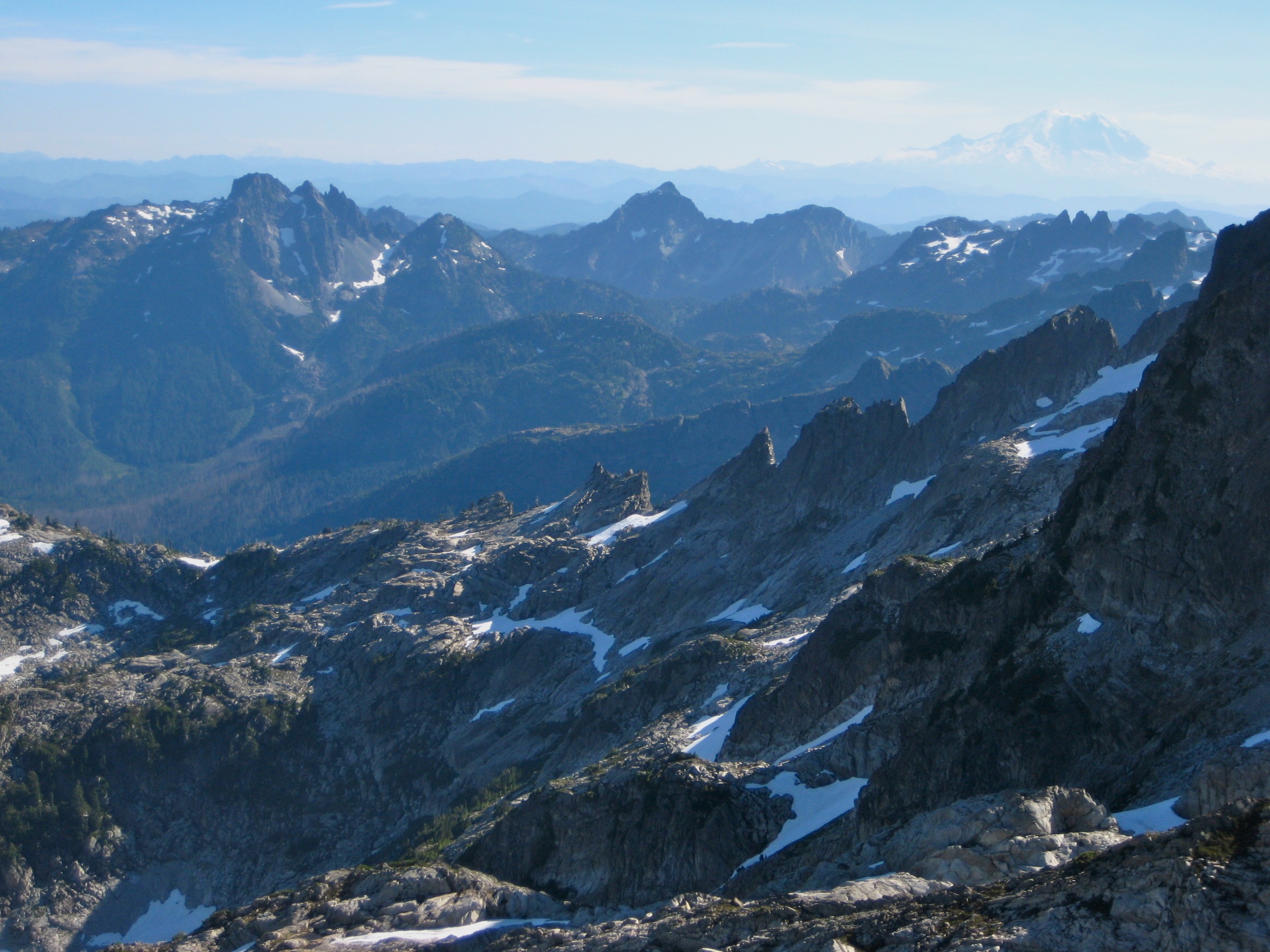 Three Queens mountain and Hibox Peak in the Snoqualmie Mountains as seen from Little Big Chief Peak in the Alpine Lakes Wilderness