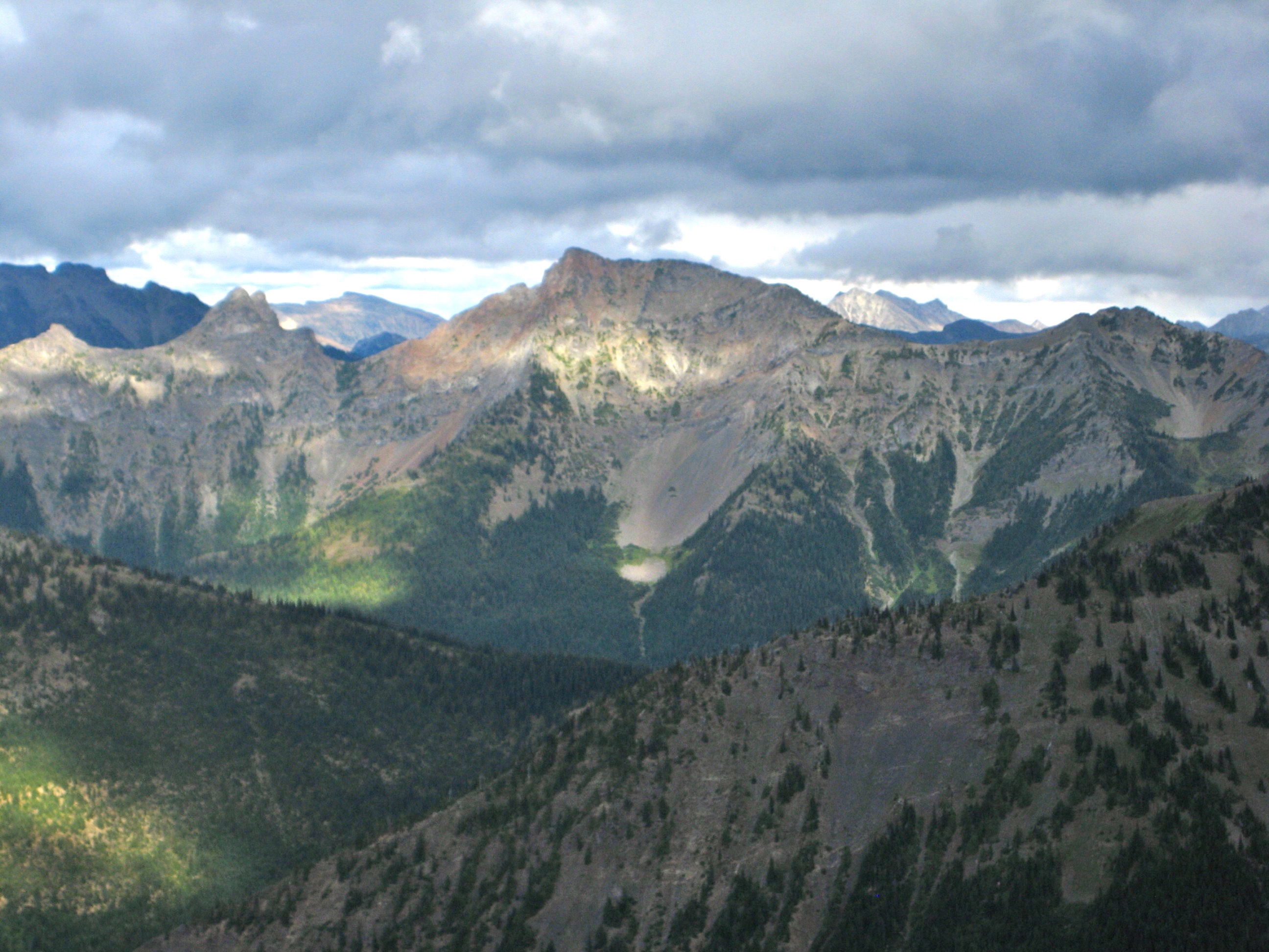 sunsine through the high clouds on Daemon Peak in the Skagit Mountains as seen the Jack Mountain High Circuit