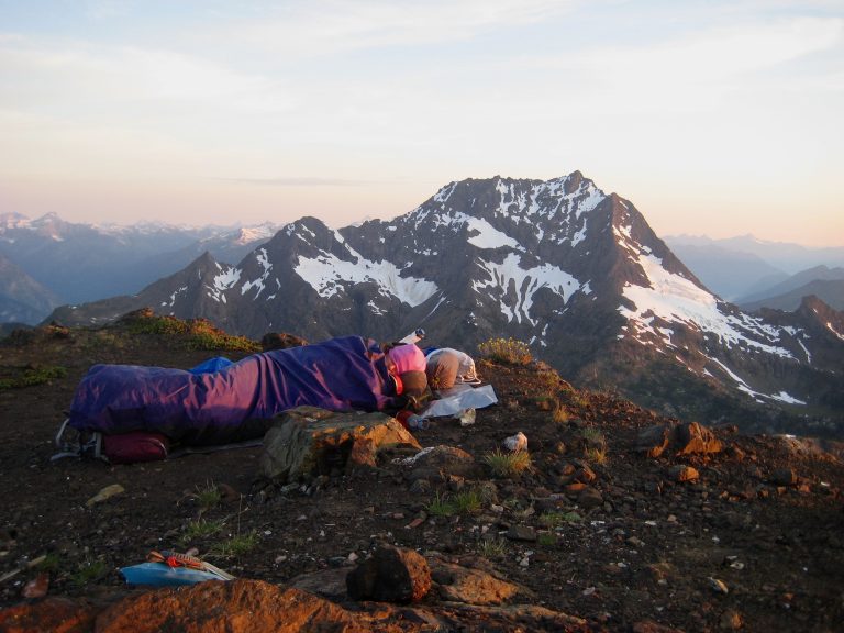 A mountain climber bivouacs on Crater Mtn summit across from Jack Mtn