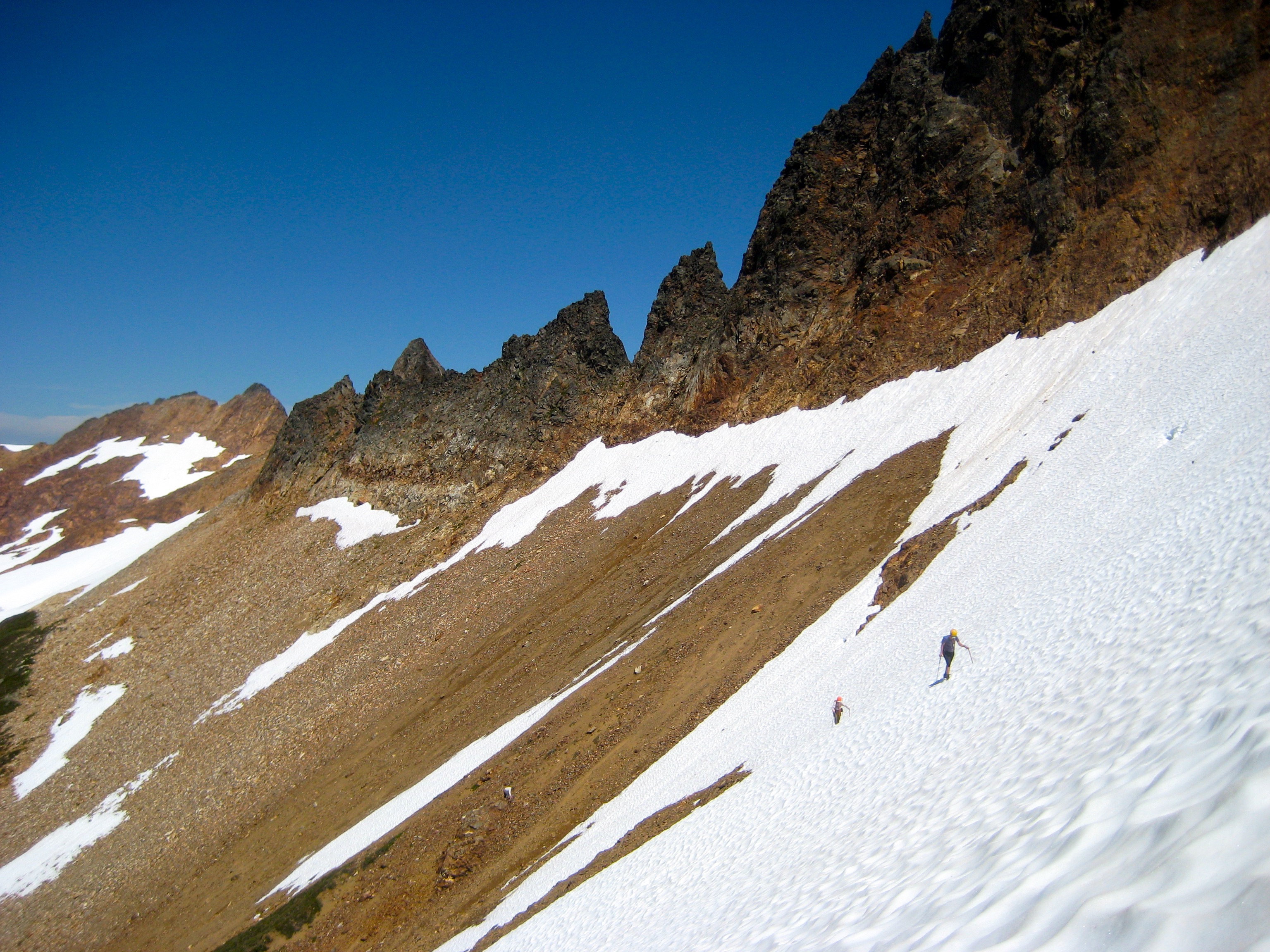 mountain climbers traversing snow slope high on Mt Misch shoulder in the Glacier Peak Wilderness