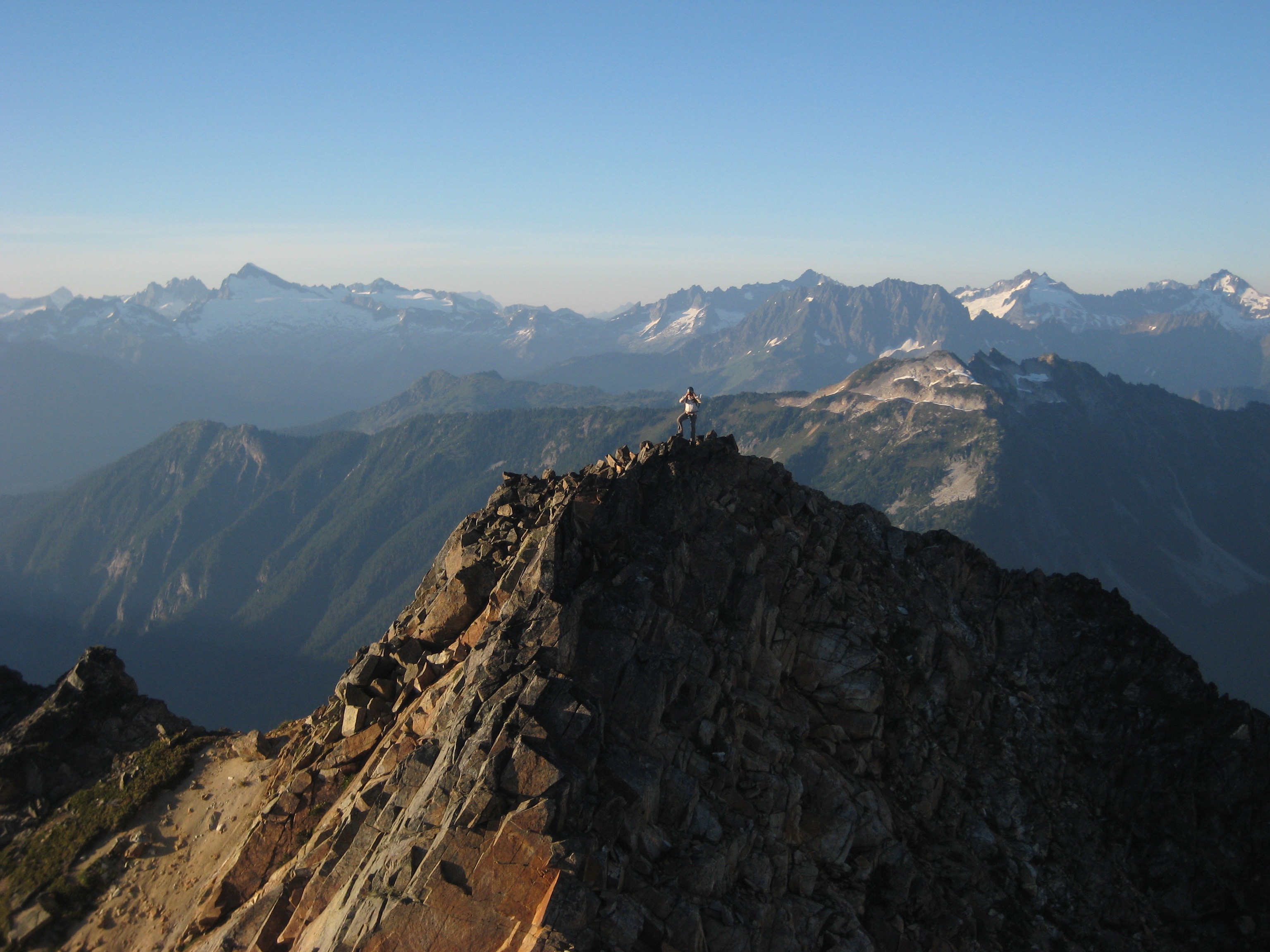 mountain climber stand on the north summit of Mt Buckindy in the Glacier Peak Wilderness