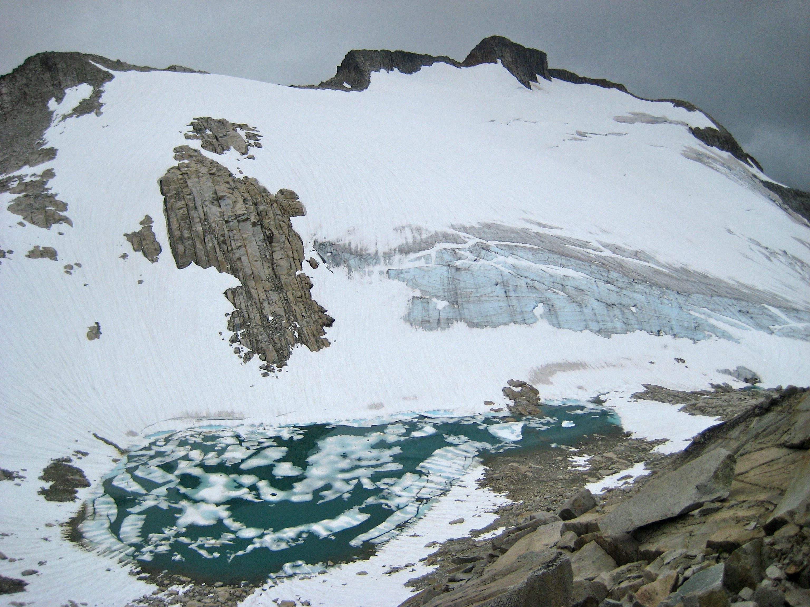 looking down the snow covered slopes and ice covered Wiley Lake bowl