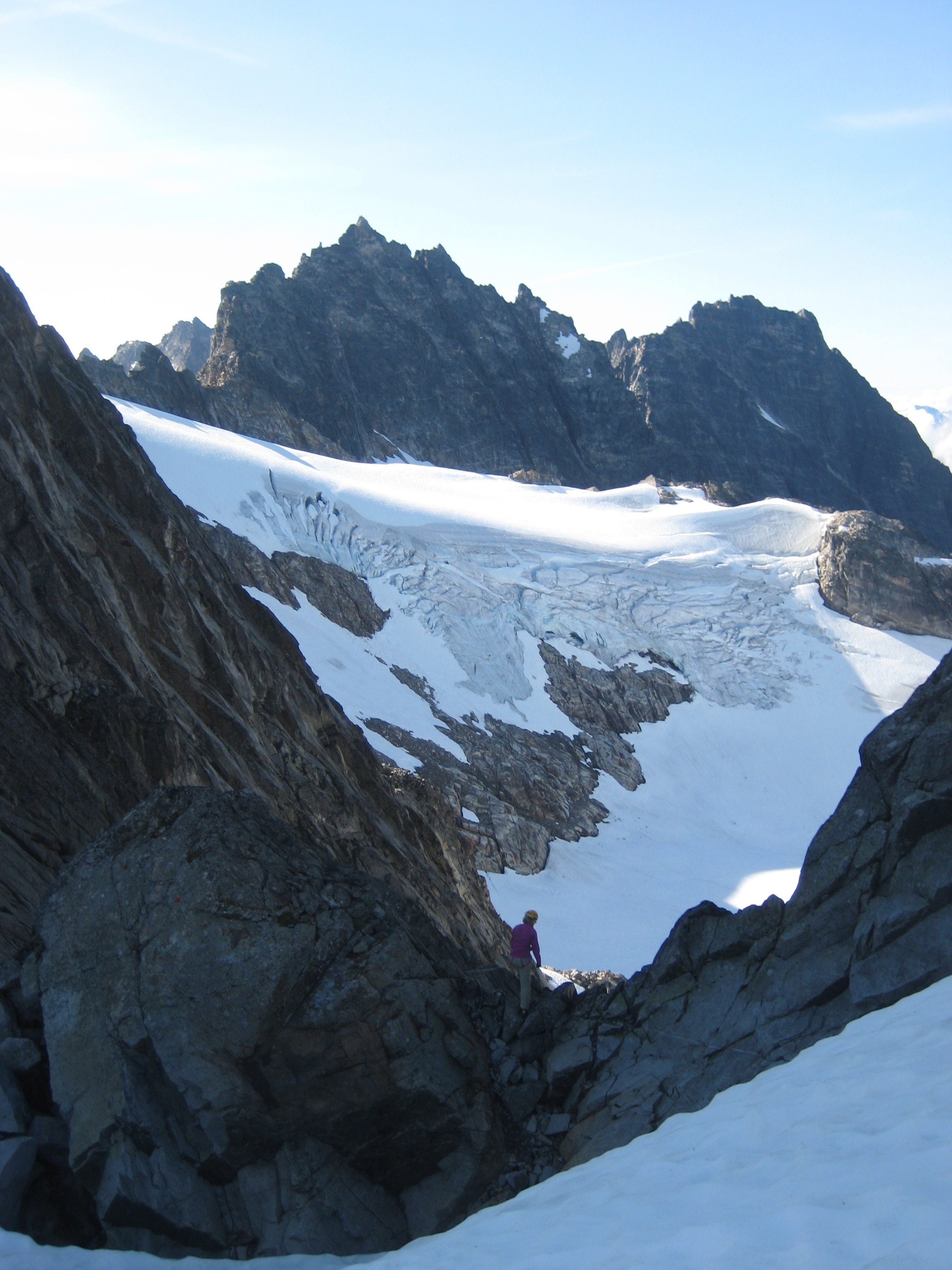 climber enjoying the view of Crooked Thumb Peak and Phantom Peak from the Challenger notch just below West Challenger Peak