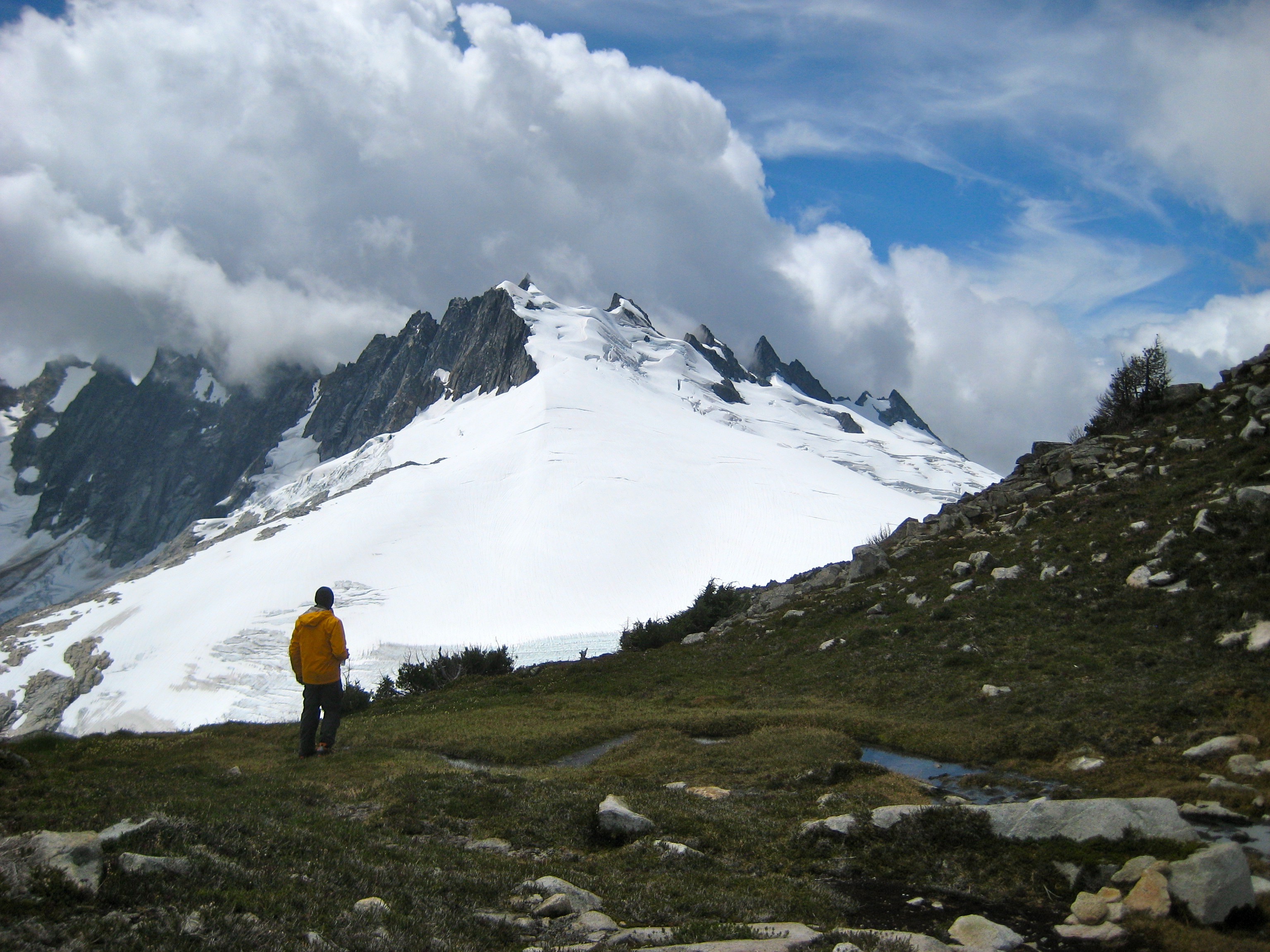 climber enjoying the view of Mt Challenger from the west end of Wiley Ridge in North Cascades National Park