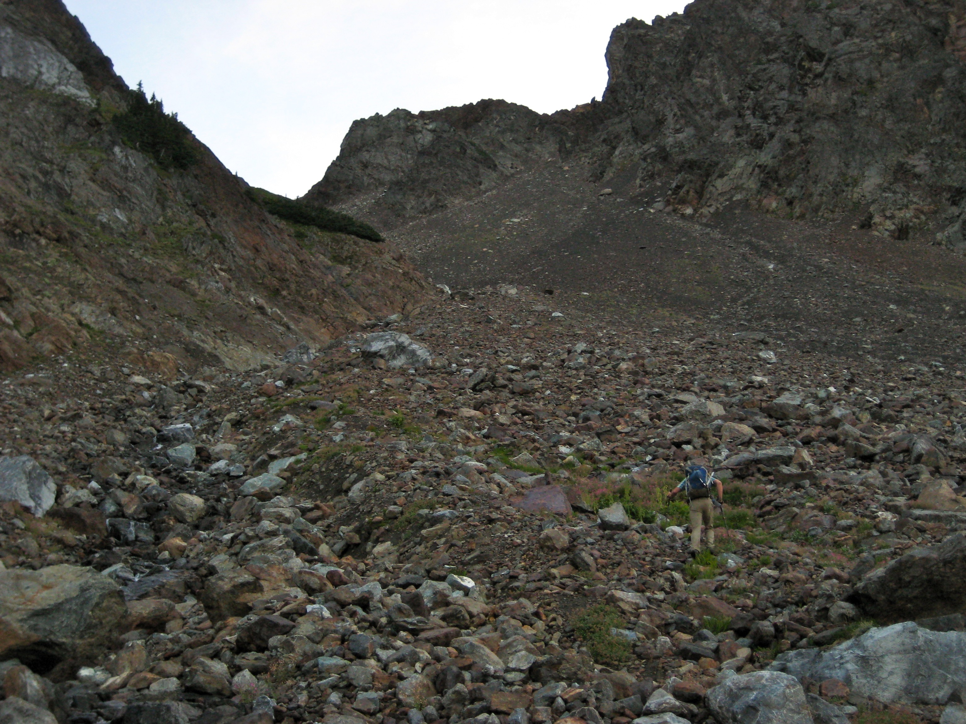 mountain climber heading up scree filled south couloir on Welch Peak in the Cheam Range
