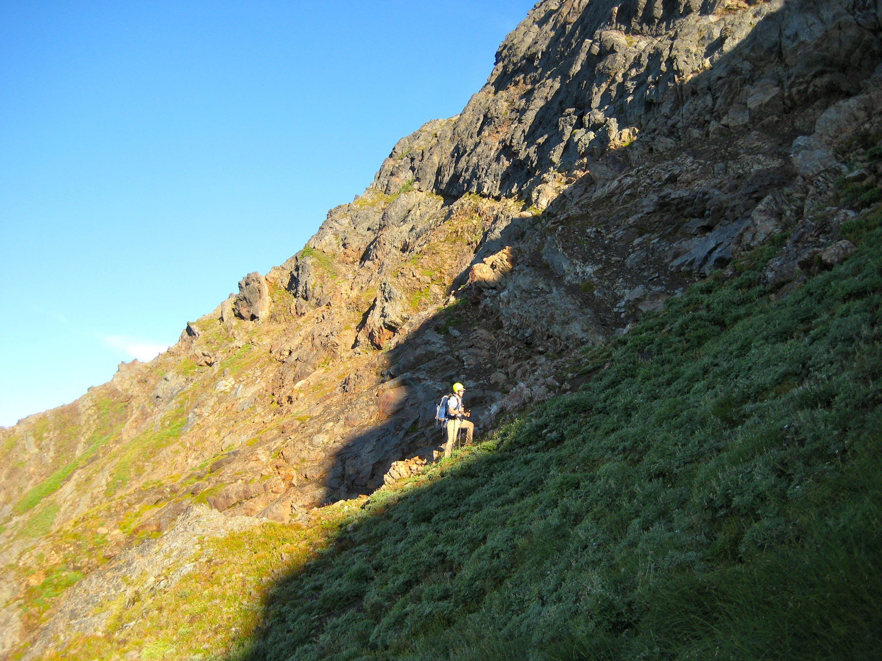mountain climber hitting the sun line in the heather on the south side of Welch Peak in the Cheam Range