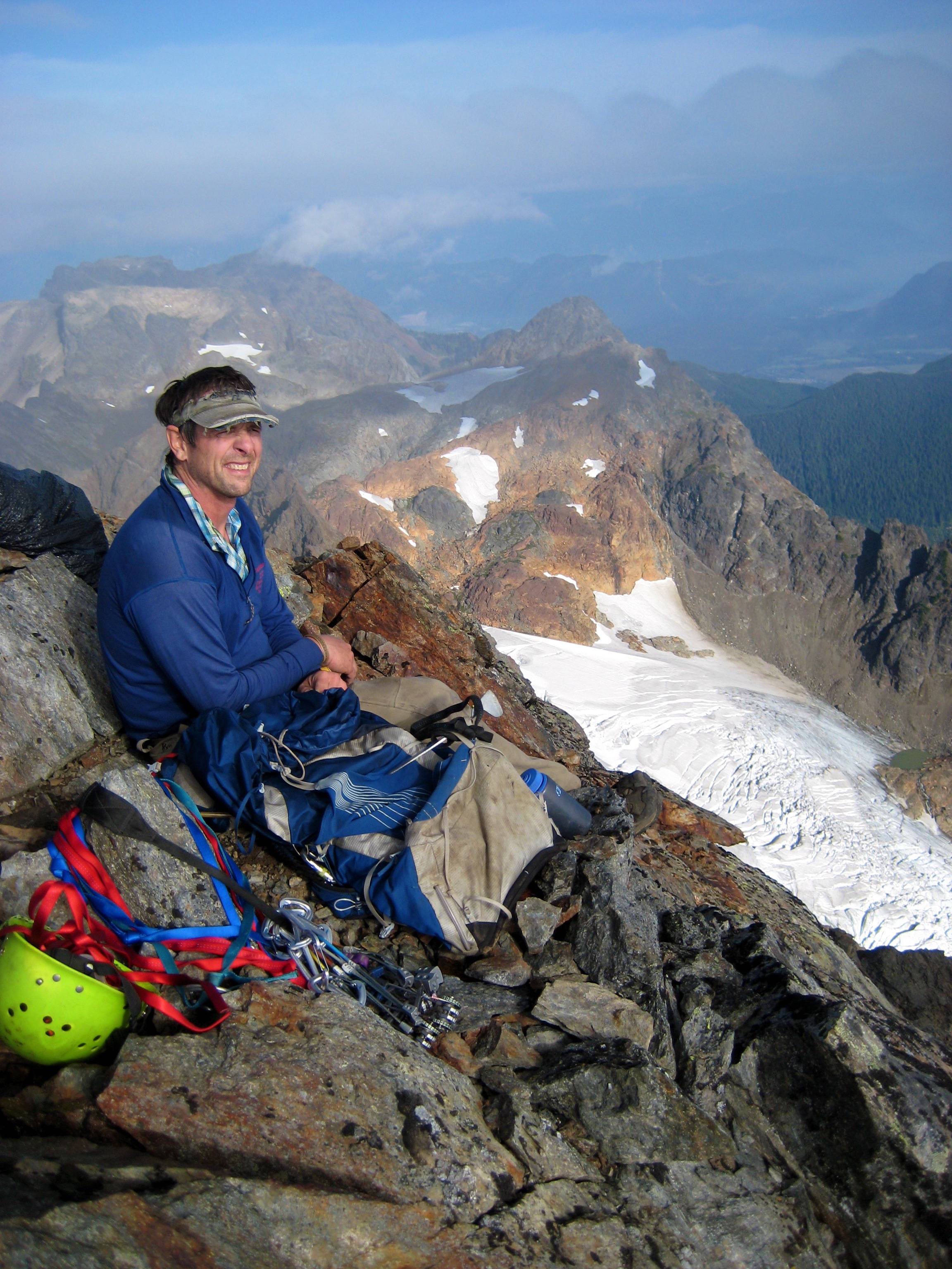 mountain climber taking a break on the summit of Welch Peak in the Cheam Range