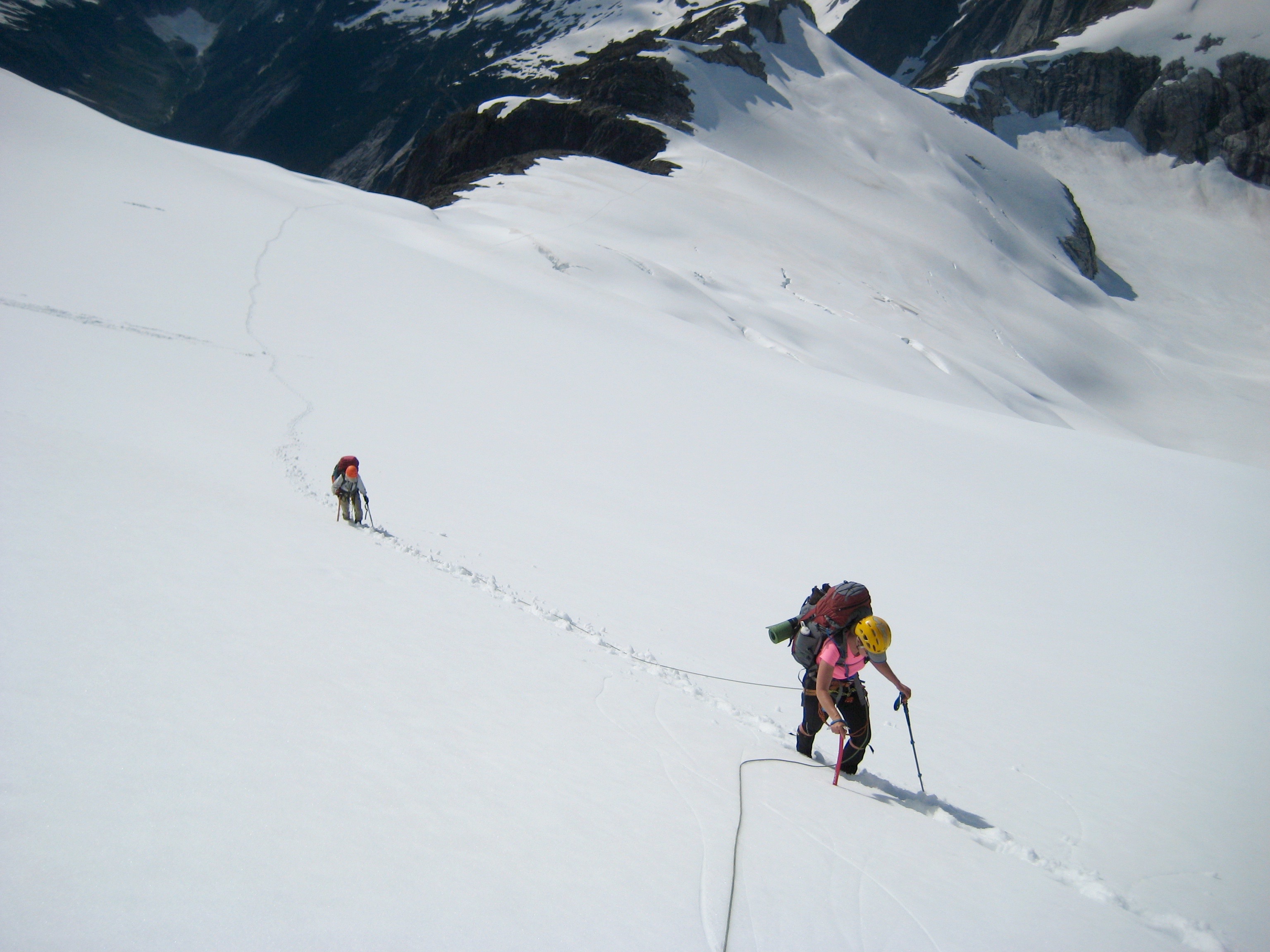 mountain climbers traversing sleep snow slope heading to the upper Challenger Glacier in the Northern Pickets