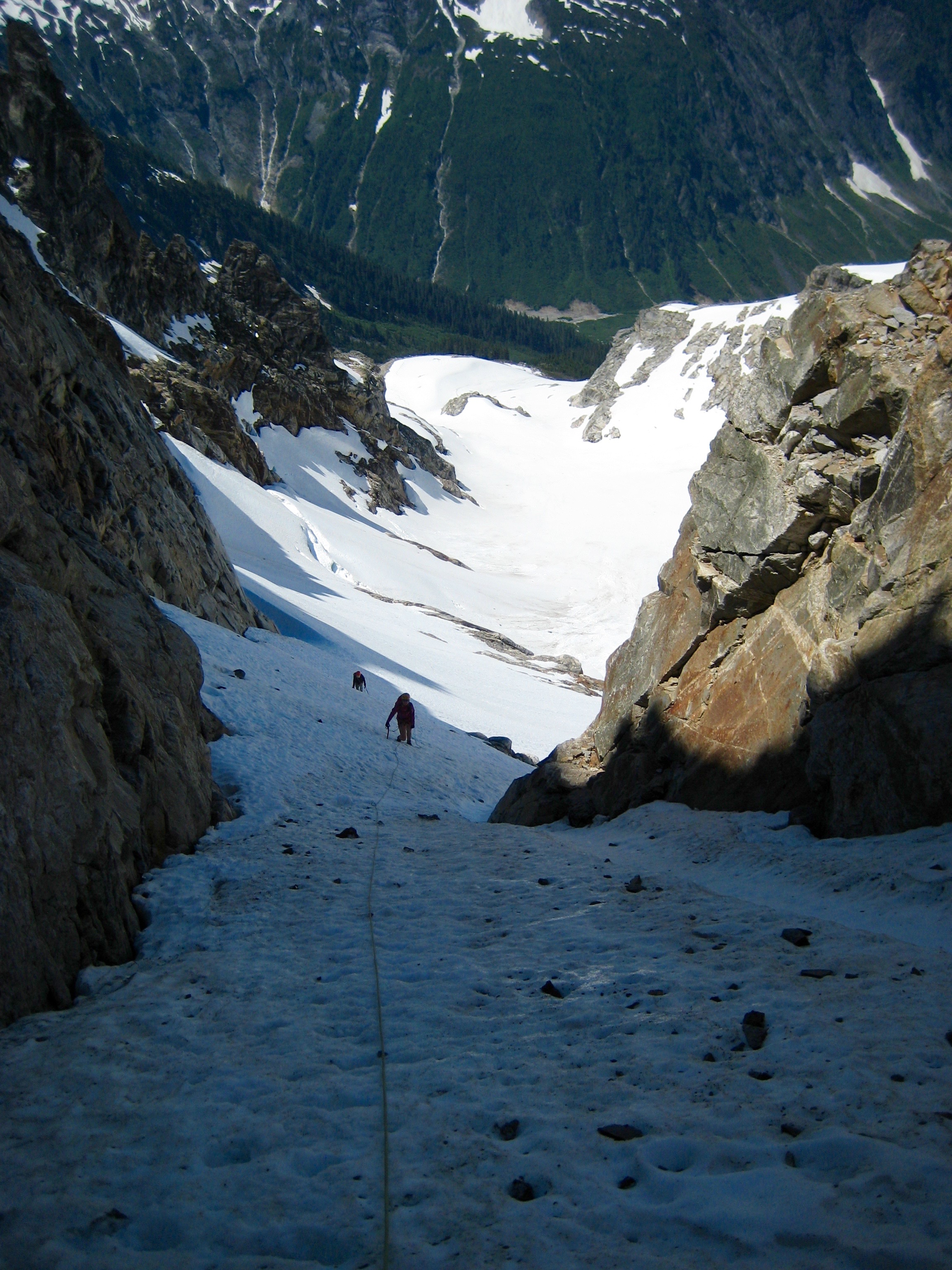 mountain climbers booting up Crooked Thumb key snow couloir in the Northern Pickets