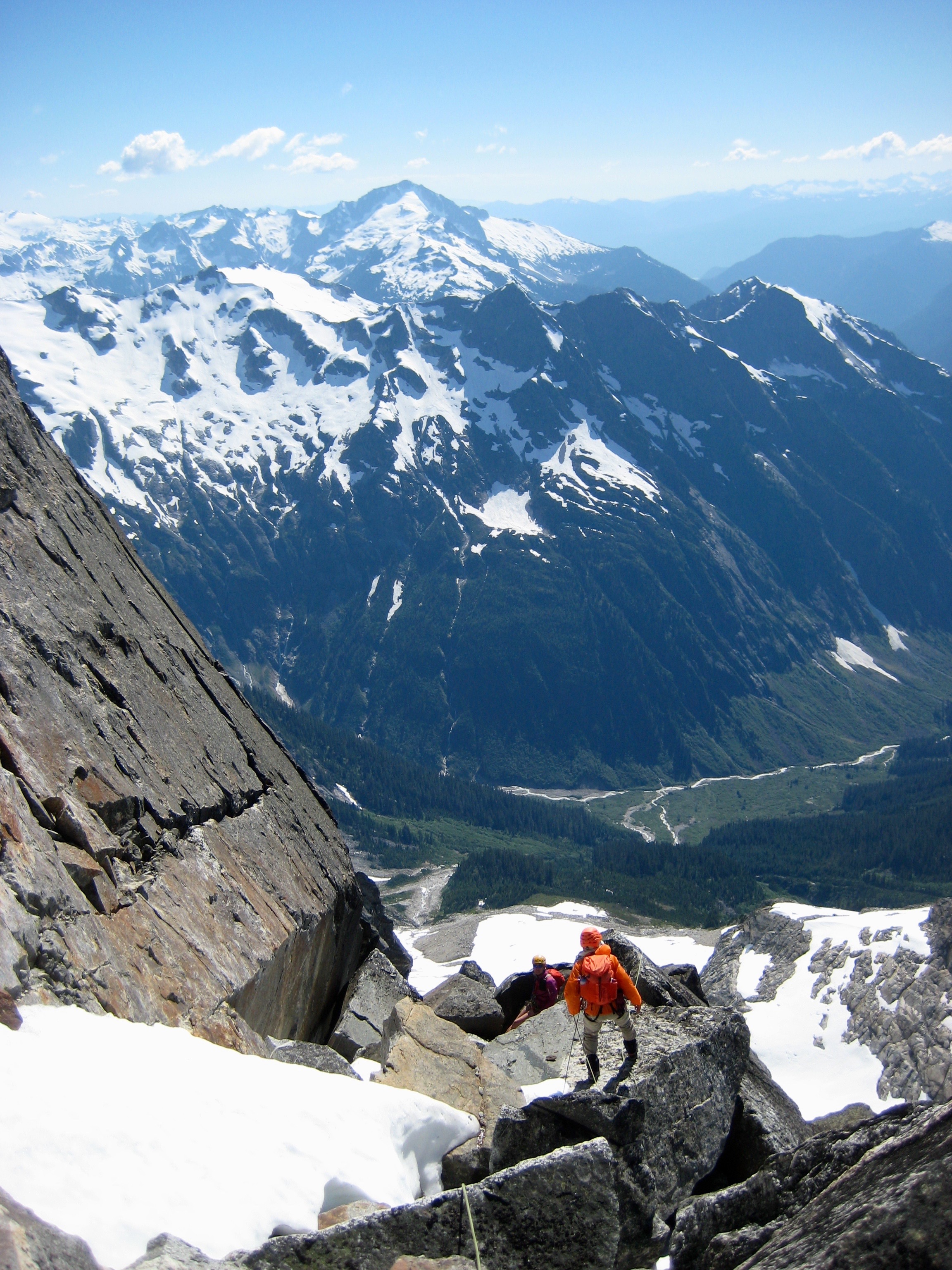 mountain climbers approaching headwall on the West Face of Crooked Thumb Peak with giant boulders