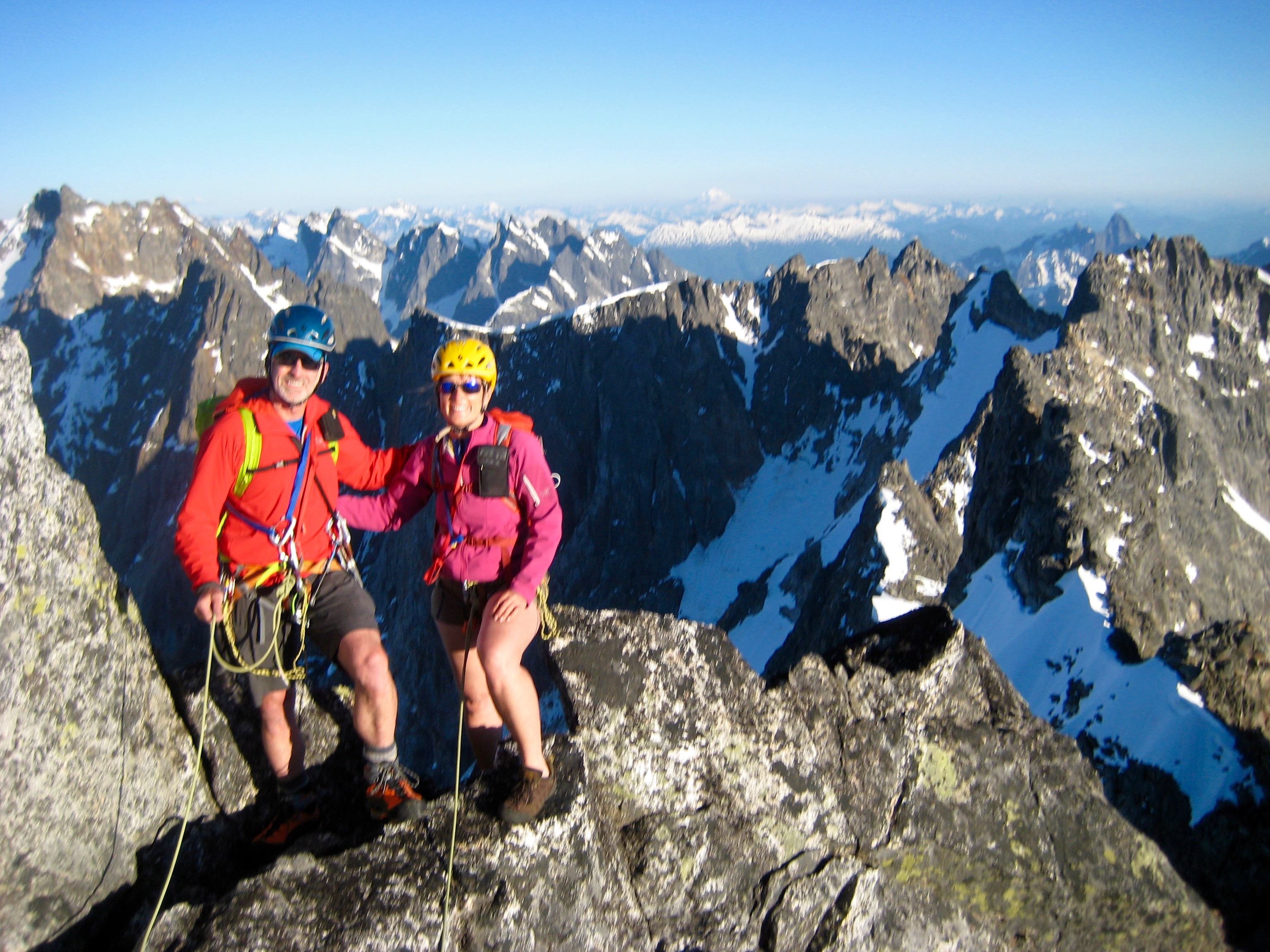Mountain climbers on the Crooked Thumb Peak summit with the rest of the Northern Picket Range