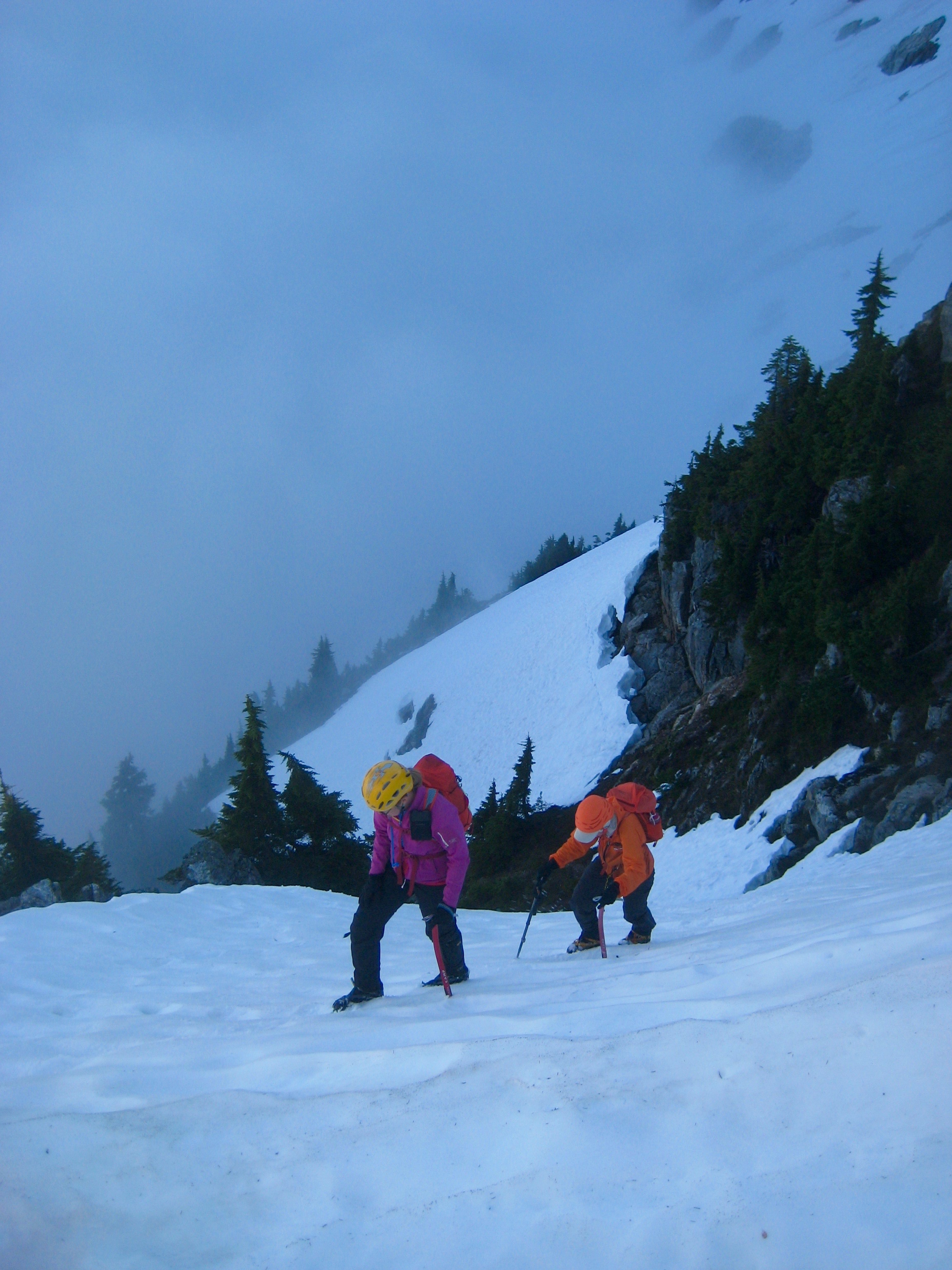 mountain climbers booting up snow couloir leading to the Phantom Peak Buttress