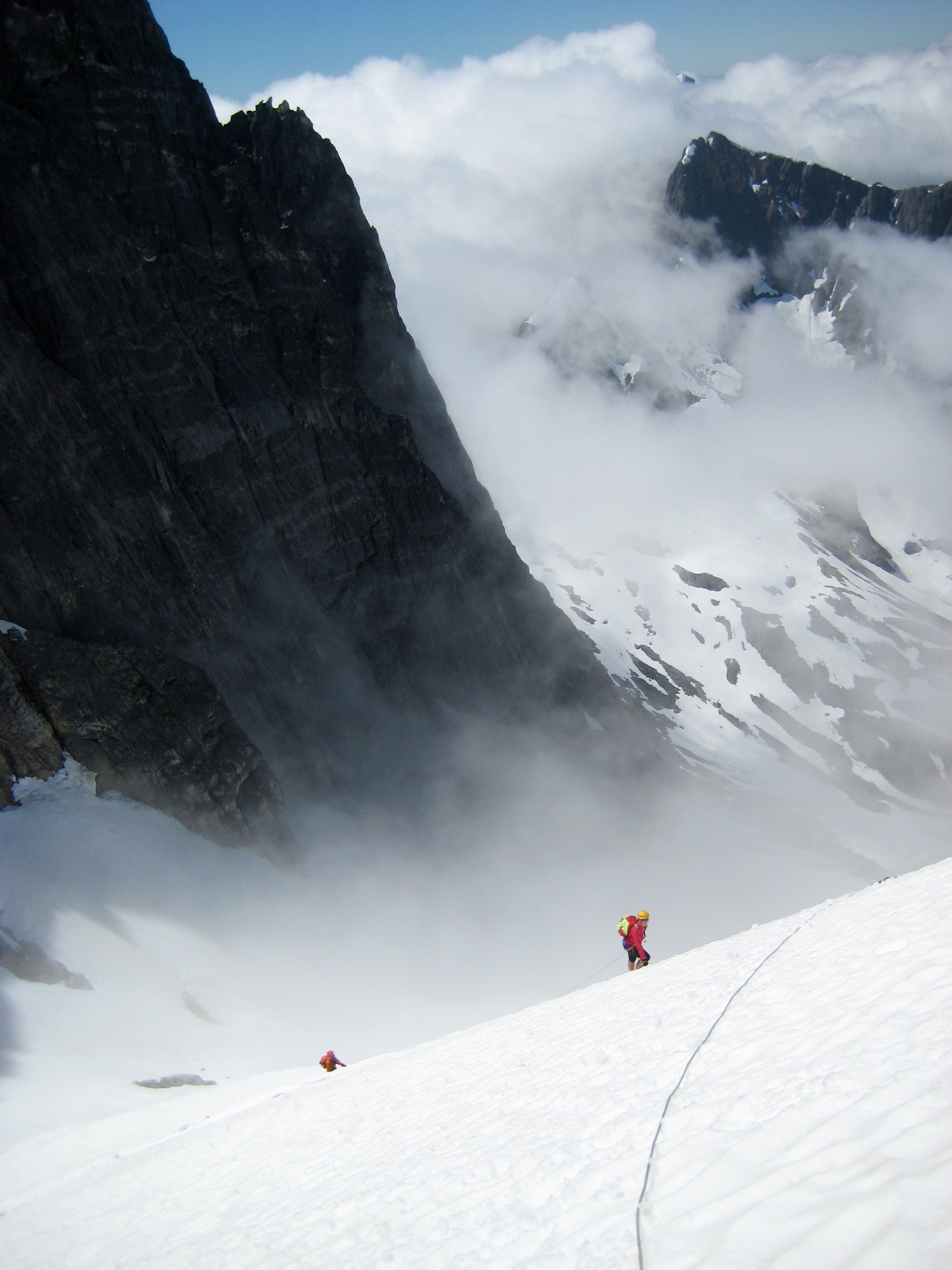 roped mountain climbers booting up snow finger high on Phantom Peak in the Northern Picket Range