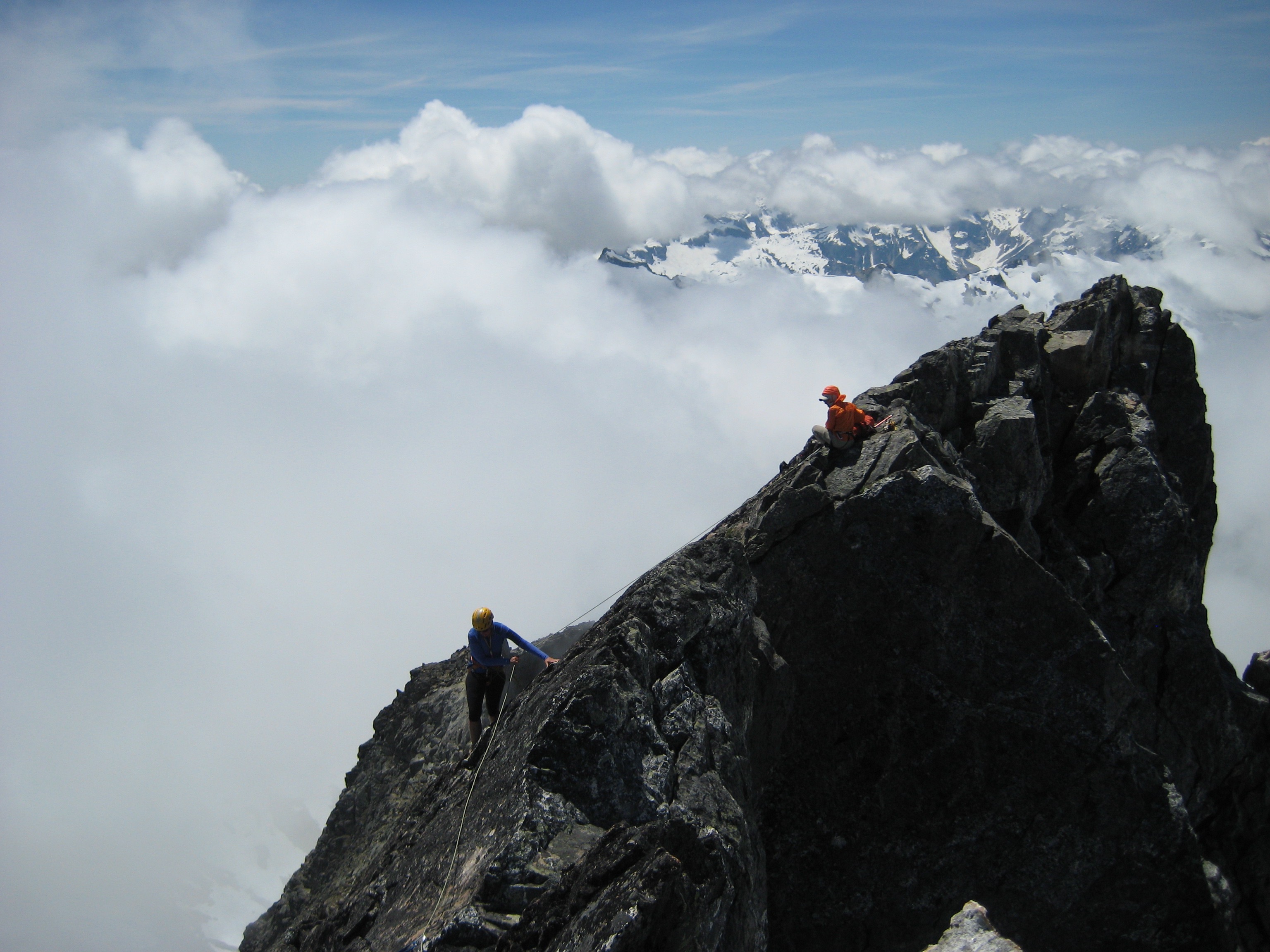 mountain climbers scrambling over steep rocky false summit of Phantom Peak