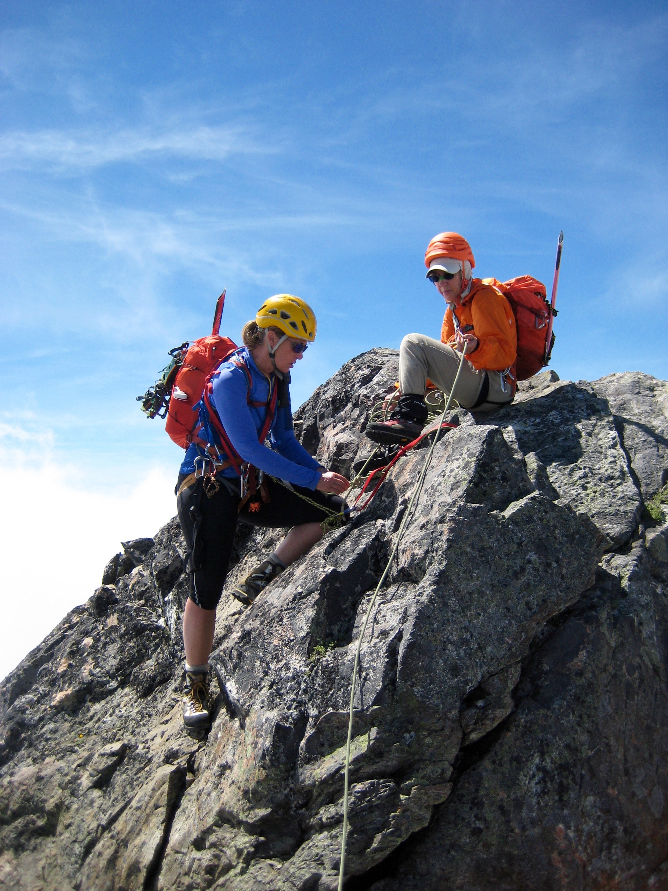 mountain climbers setting up rope anchor on the rocky false summit of Phantom Peak