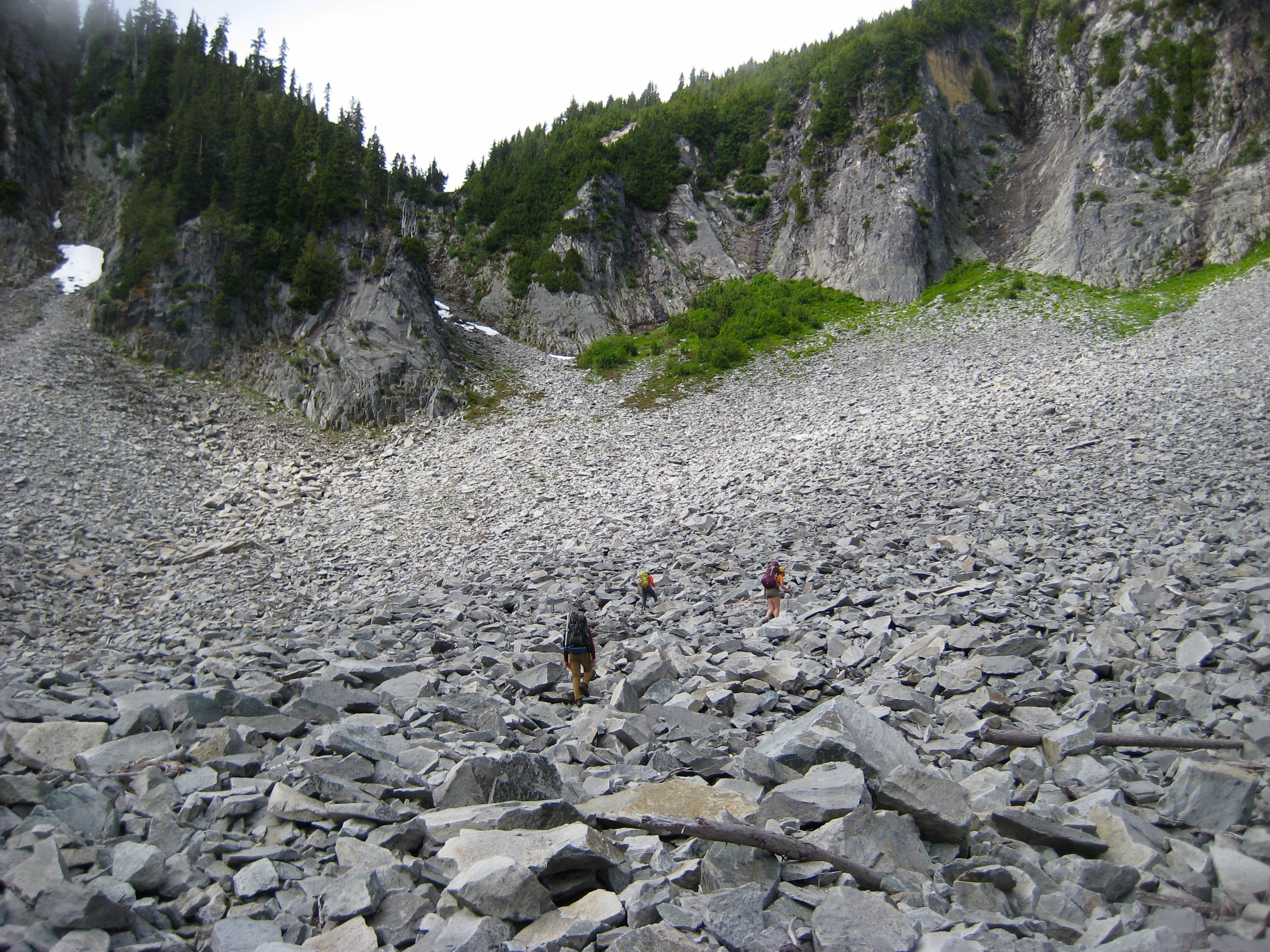 climbers assending rocky blouder field in Unicorn Basin in the Tatoosh Range in Mt Rainier National Park