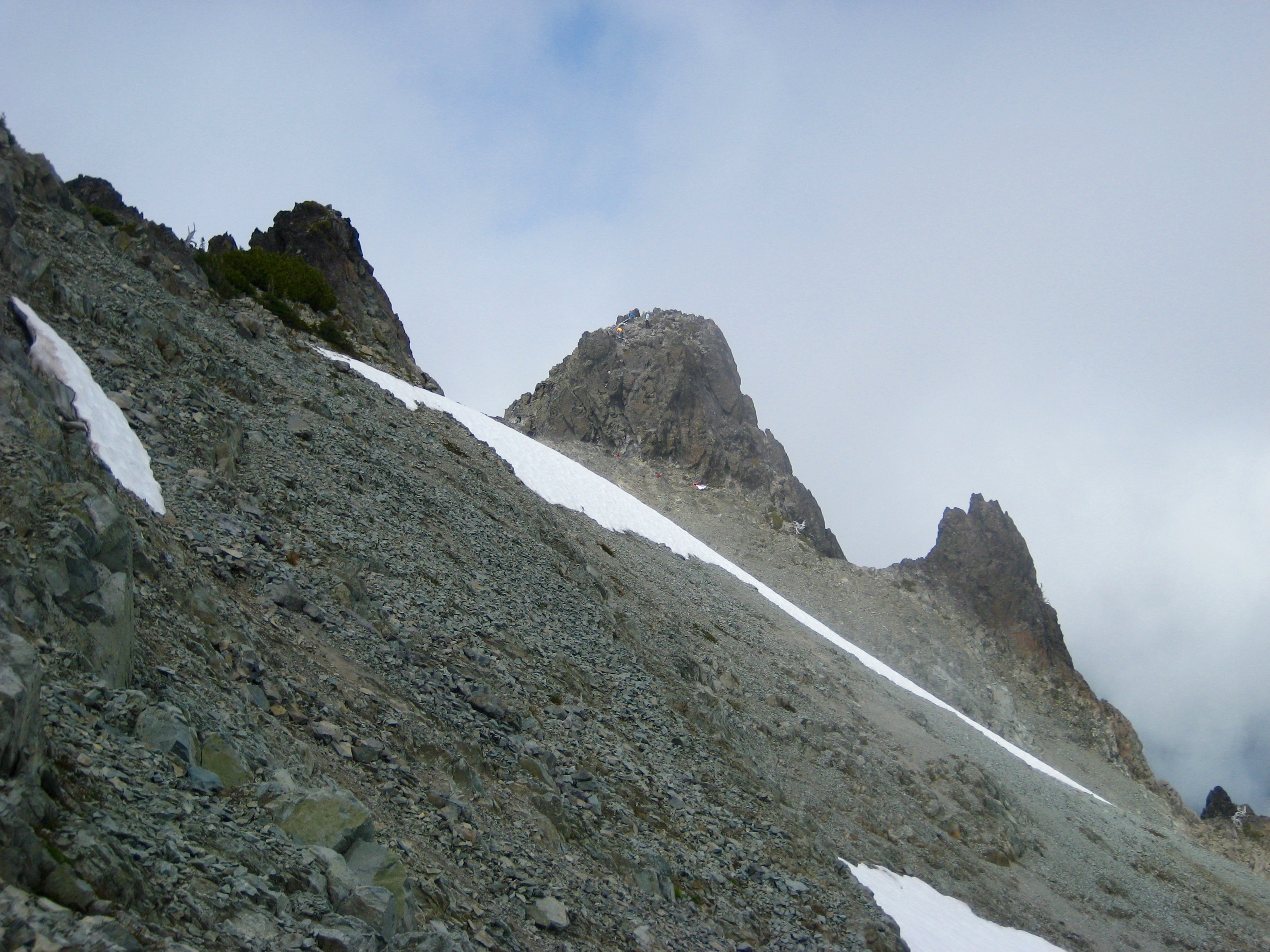 Unicorn's Horn as seen across a scree field on the shoulder of Unicorn Peak in the Tatoosh Range in Mt Rainier National Park