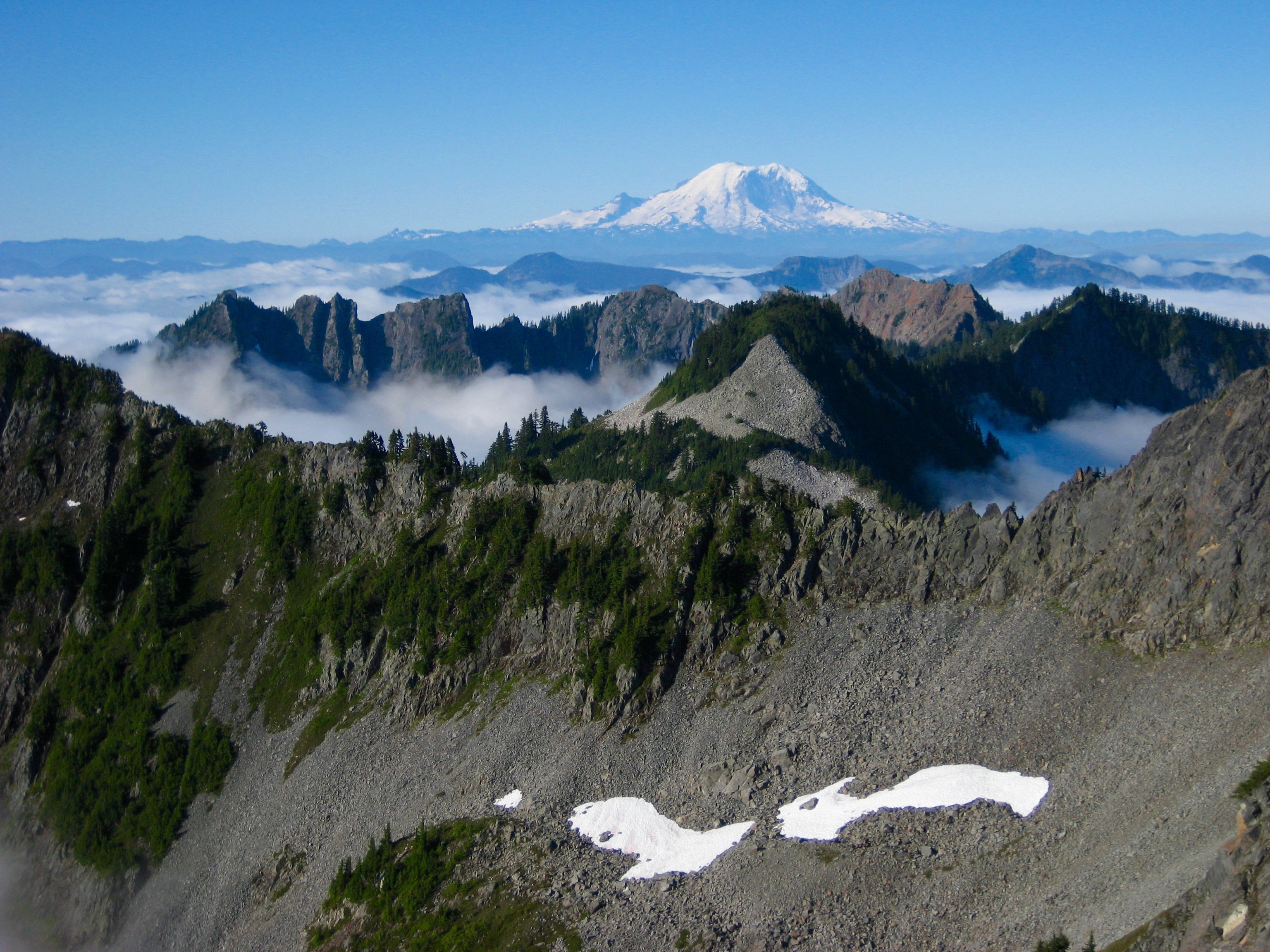 Mt Rainier over Kendall Peaks with valley fog in the Snoqualmie Mountains