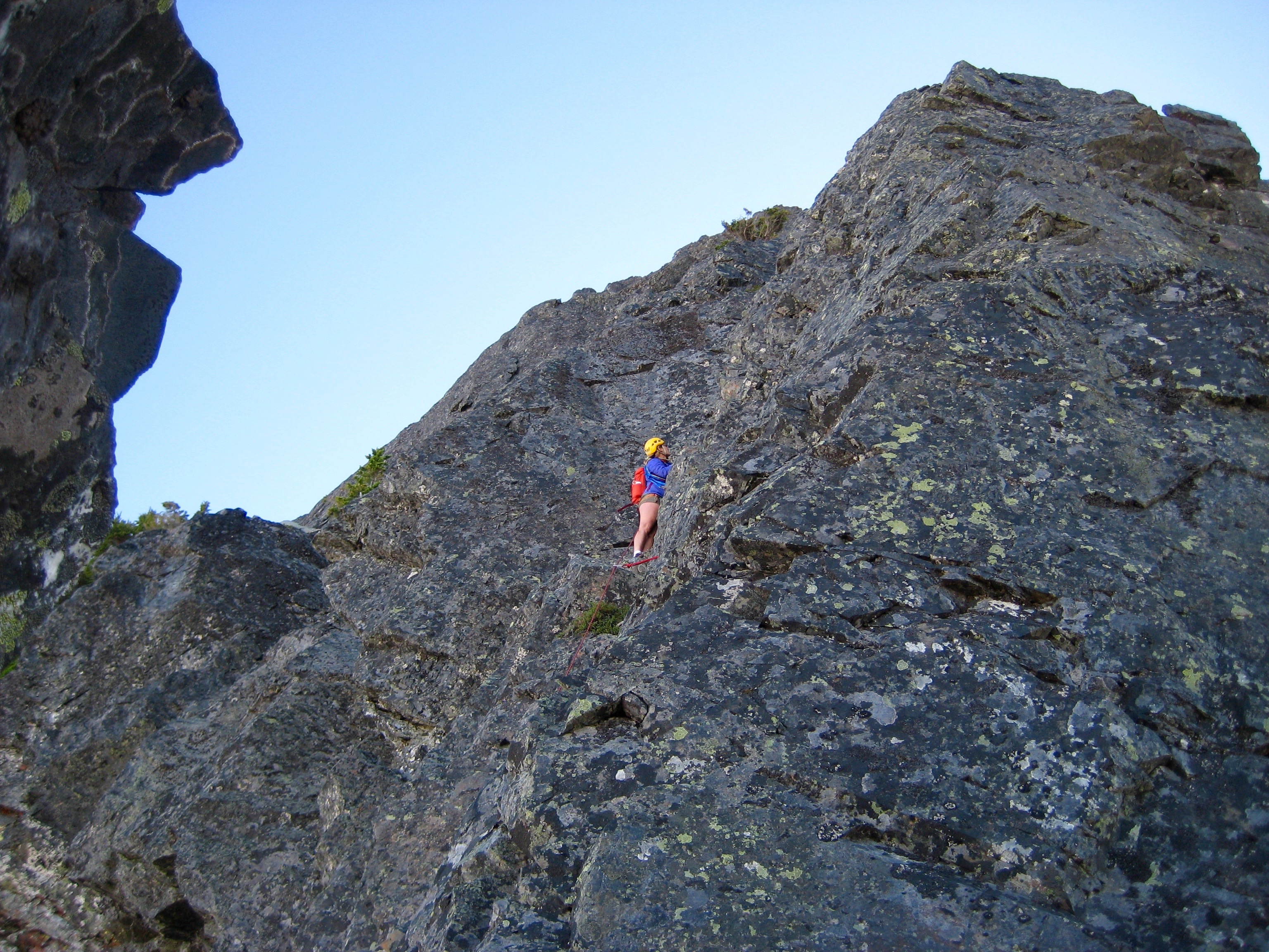 rock climber leading up 1st pitch of Mt Thomson west ridge in the Snoqualmie Mountains