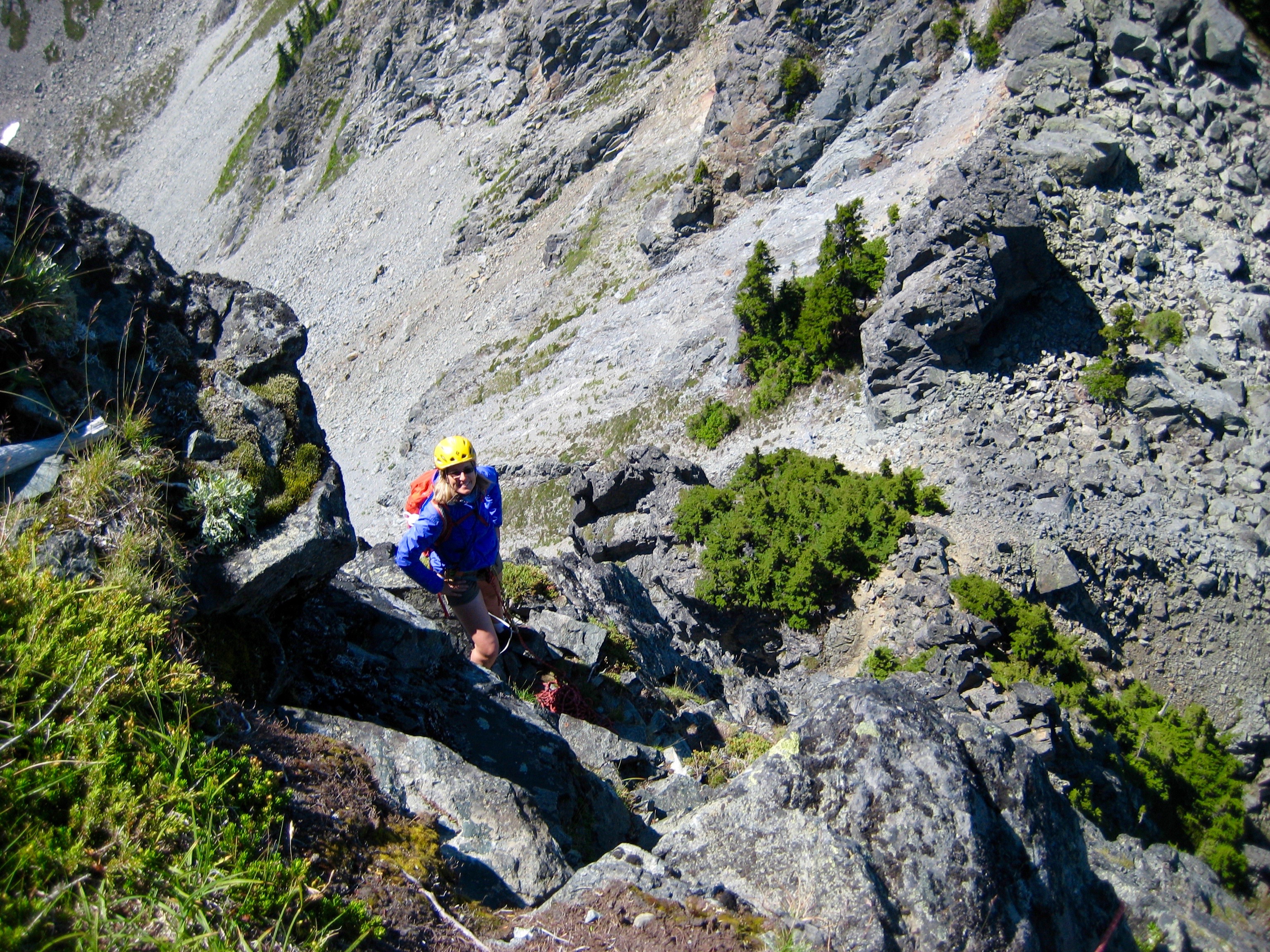 looking down the west ridge of Mt Thomson at rock climber taking a break