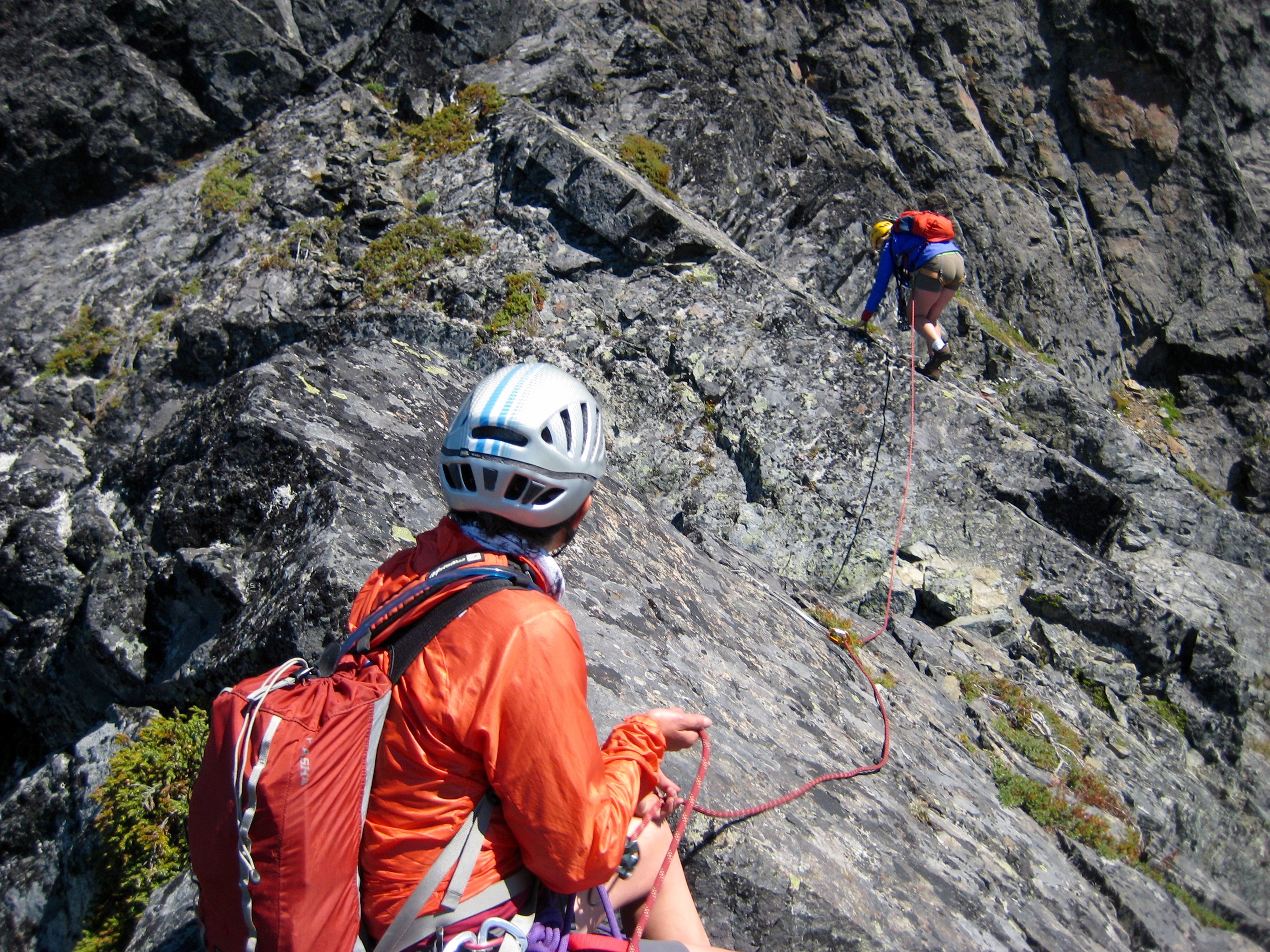 rock climber belaying lead rock climber on Mt Thomson in the Snoqualmie Mountains