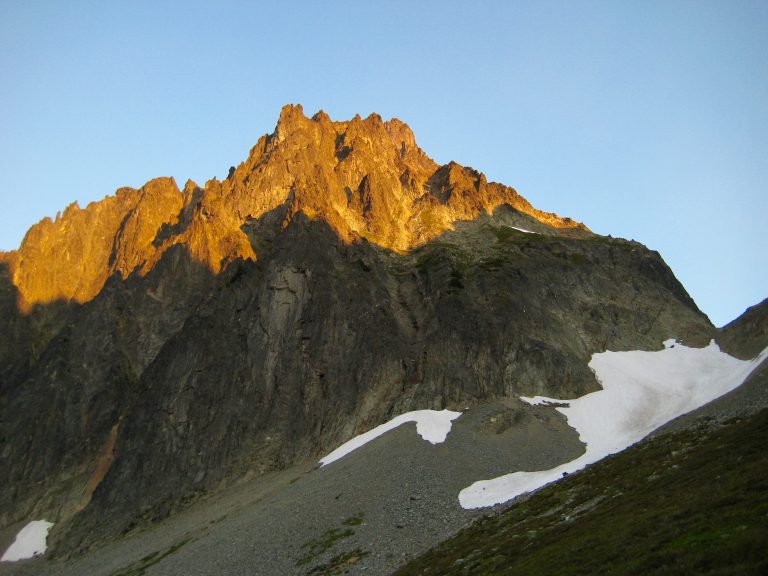 Alpenglow On East Face Of Johannesburg Mountain with linguring snow patches and scree in North Cascades National Park